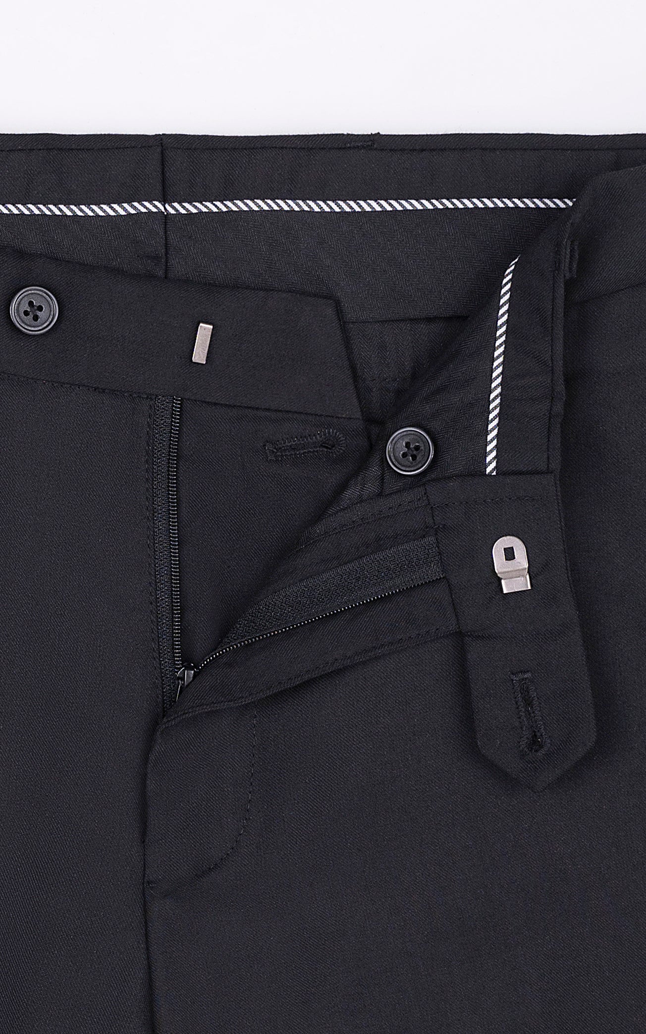 Black dress pants fly area with button and zipper details