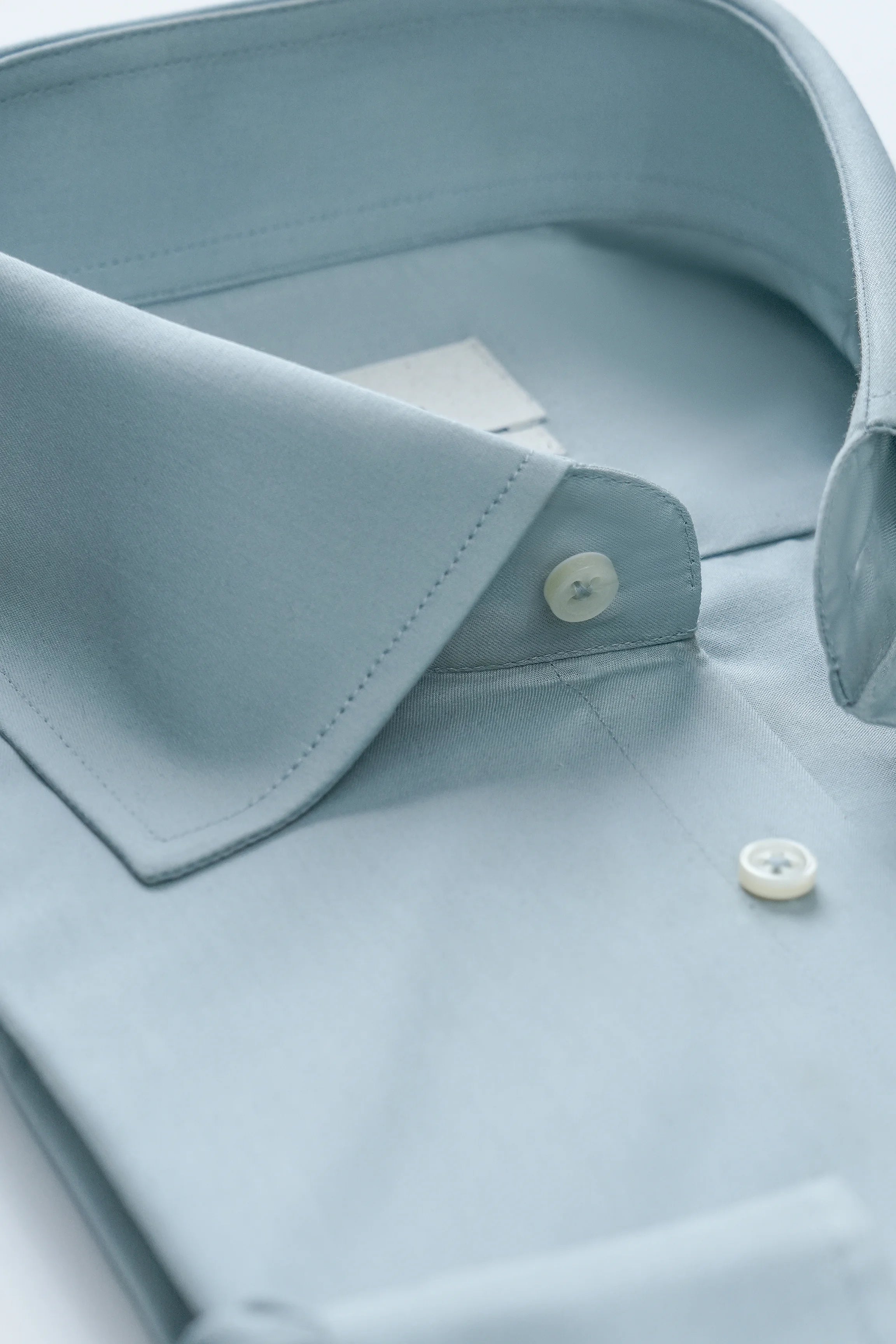 Dress shirt chest view with fold collar and small round button