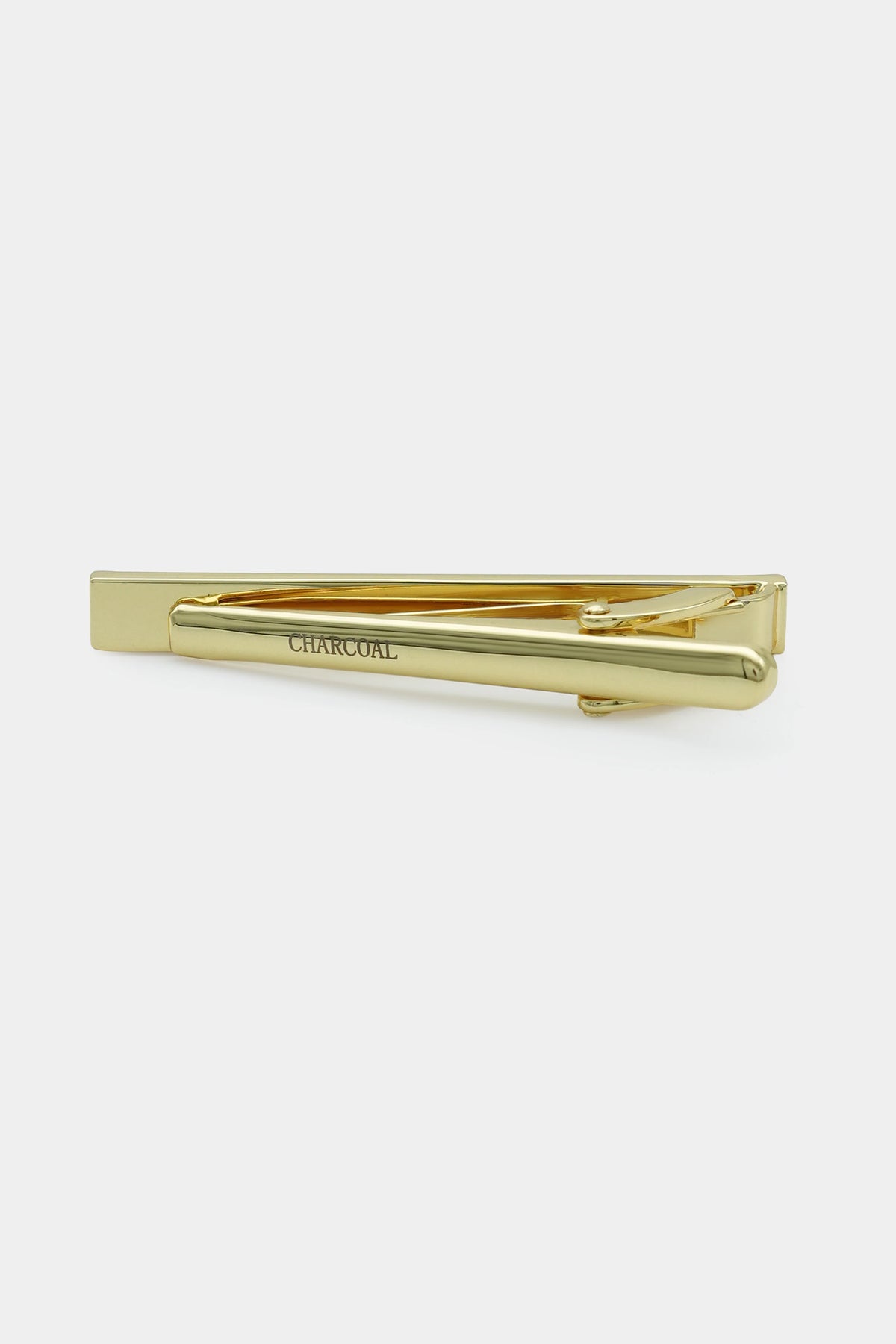 Gold tie pin with bar and clasp, engraved 'CHARCOAL'.