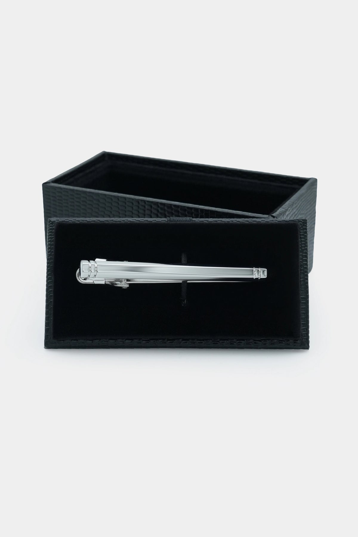 Silver tie pin in a black display box with hinged clasp