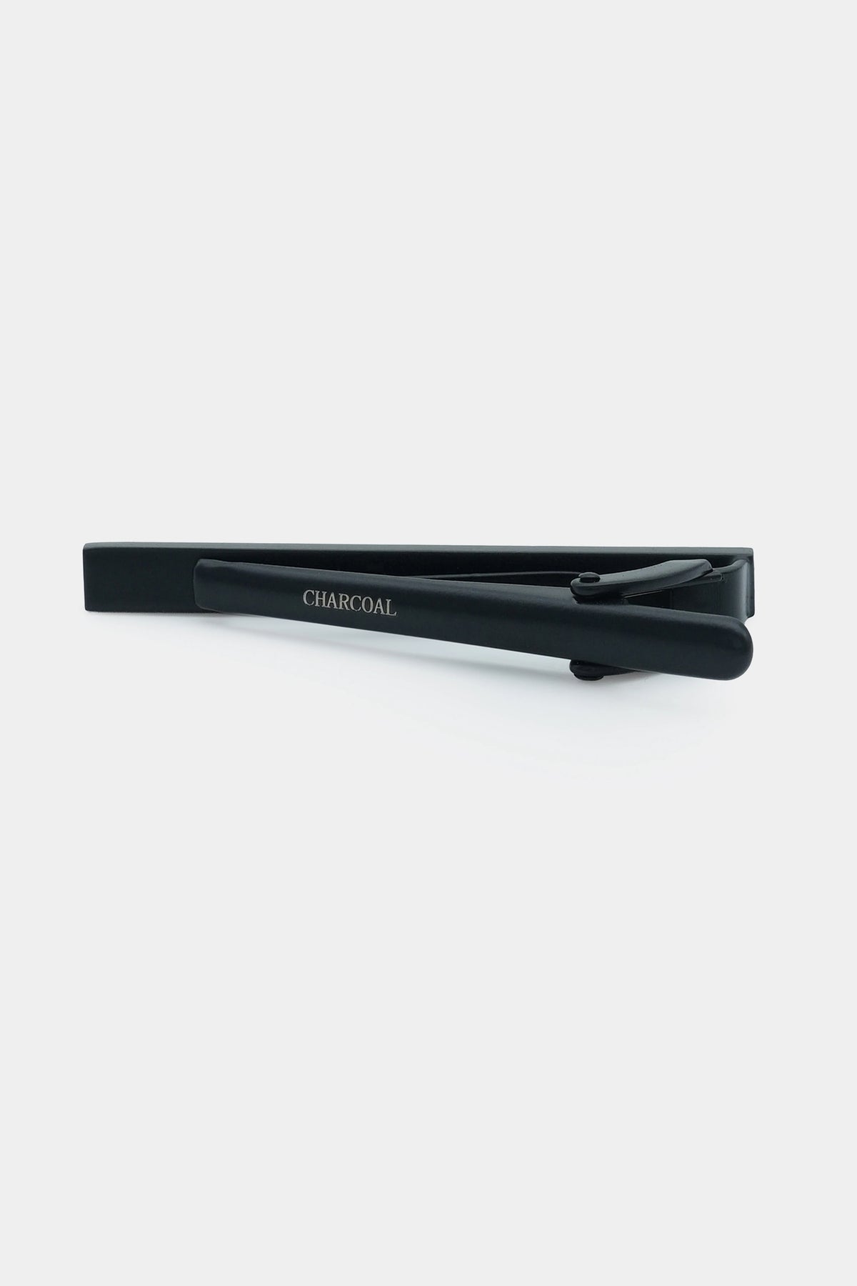 Charcoal tie pin bar clip with small clasp, centered close-up