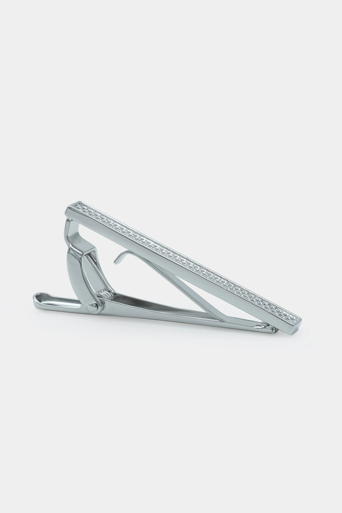Silver tie pin with textured bar and curved clasp, side view