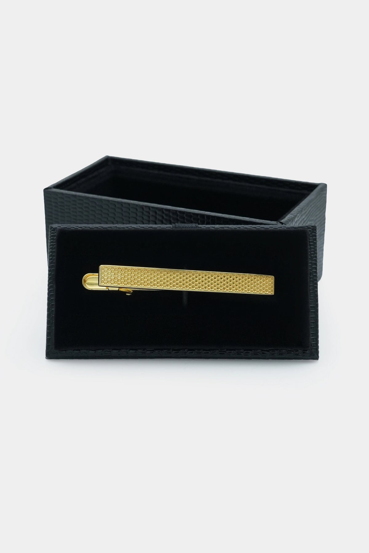 Gold tie pin in black gift box, textured bar front