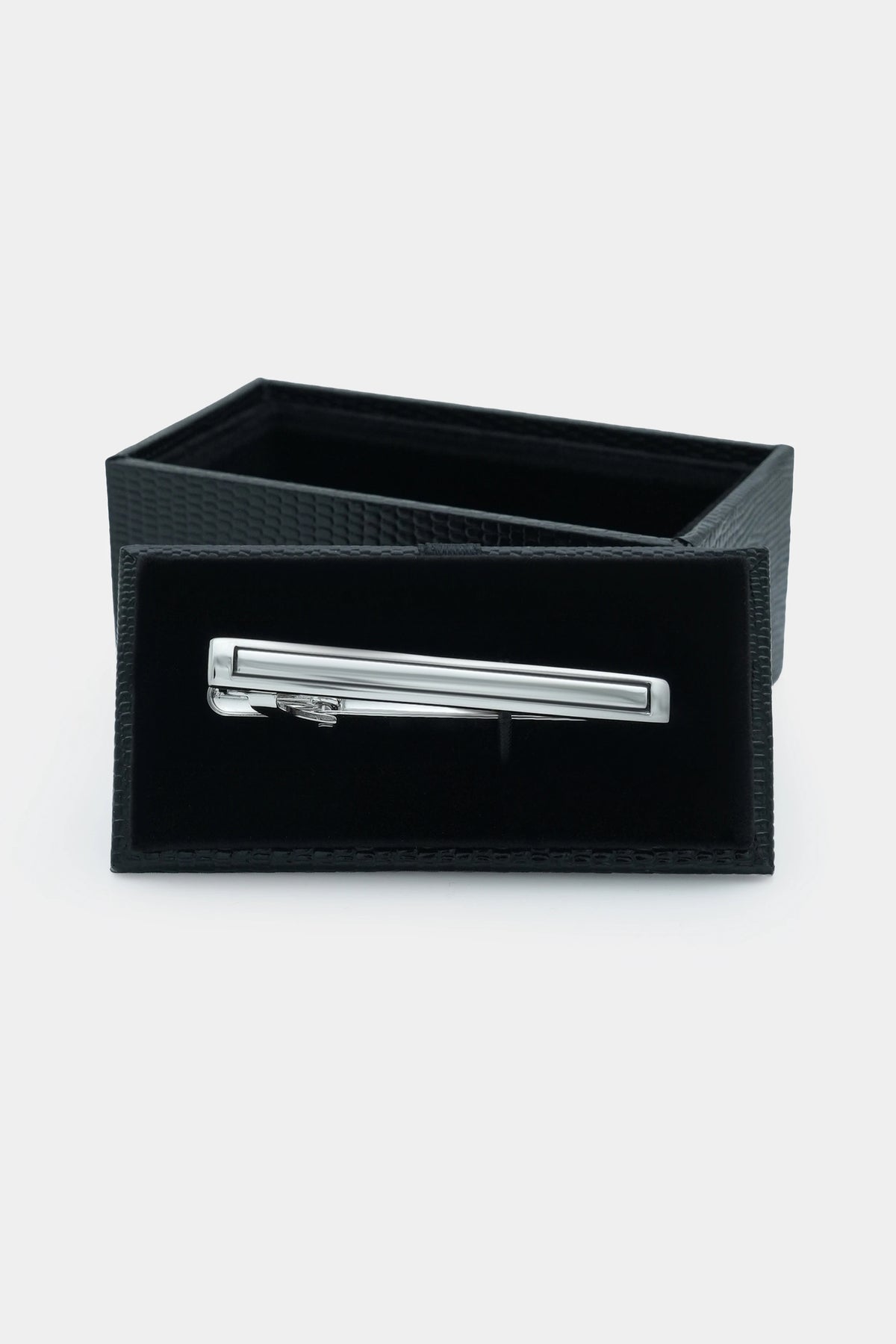 Silver tie pin set in a black fabric gift box with rectangular bar
