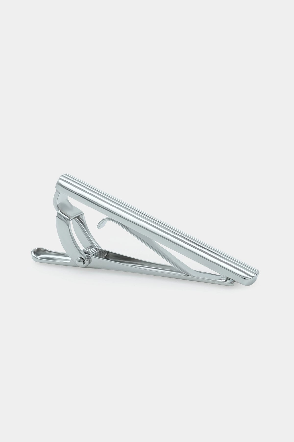 Ribbed silver tie bar with hinged clasp and curved pin back