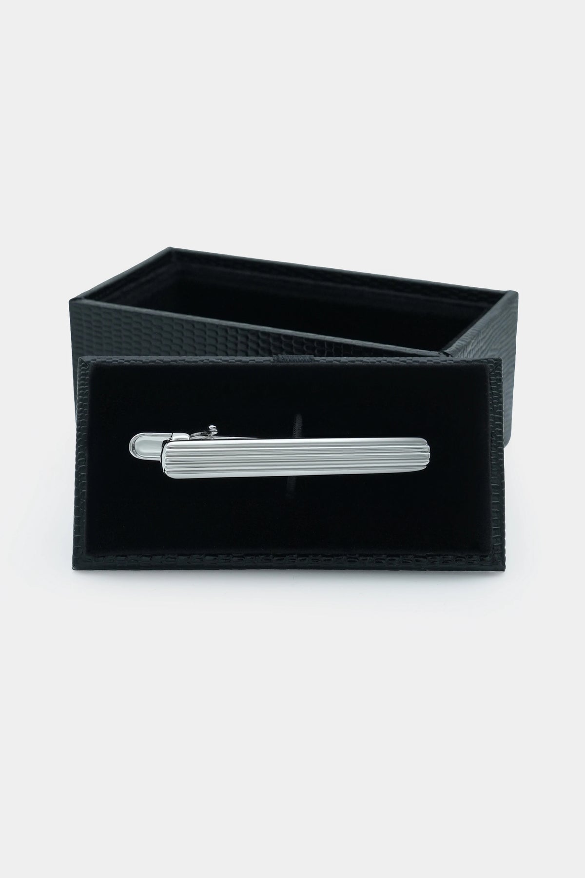 Silver ribbed tie pin in a black fabric presentation box