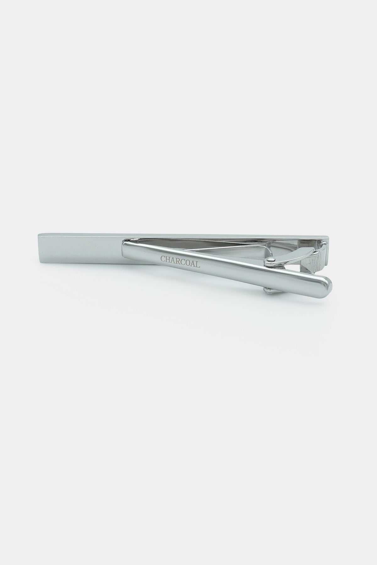 Charcoal-colored tie pin bar with silver textured front, side view