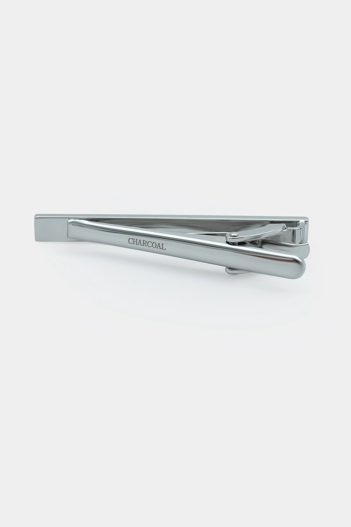 Silver tie clip with ribbed bar and "CHARCOAL" engraving