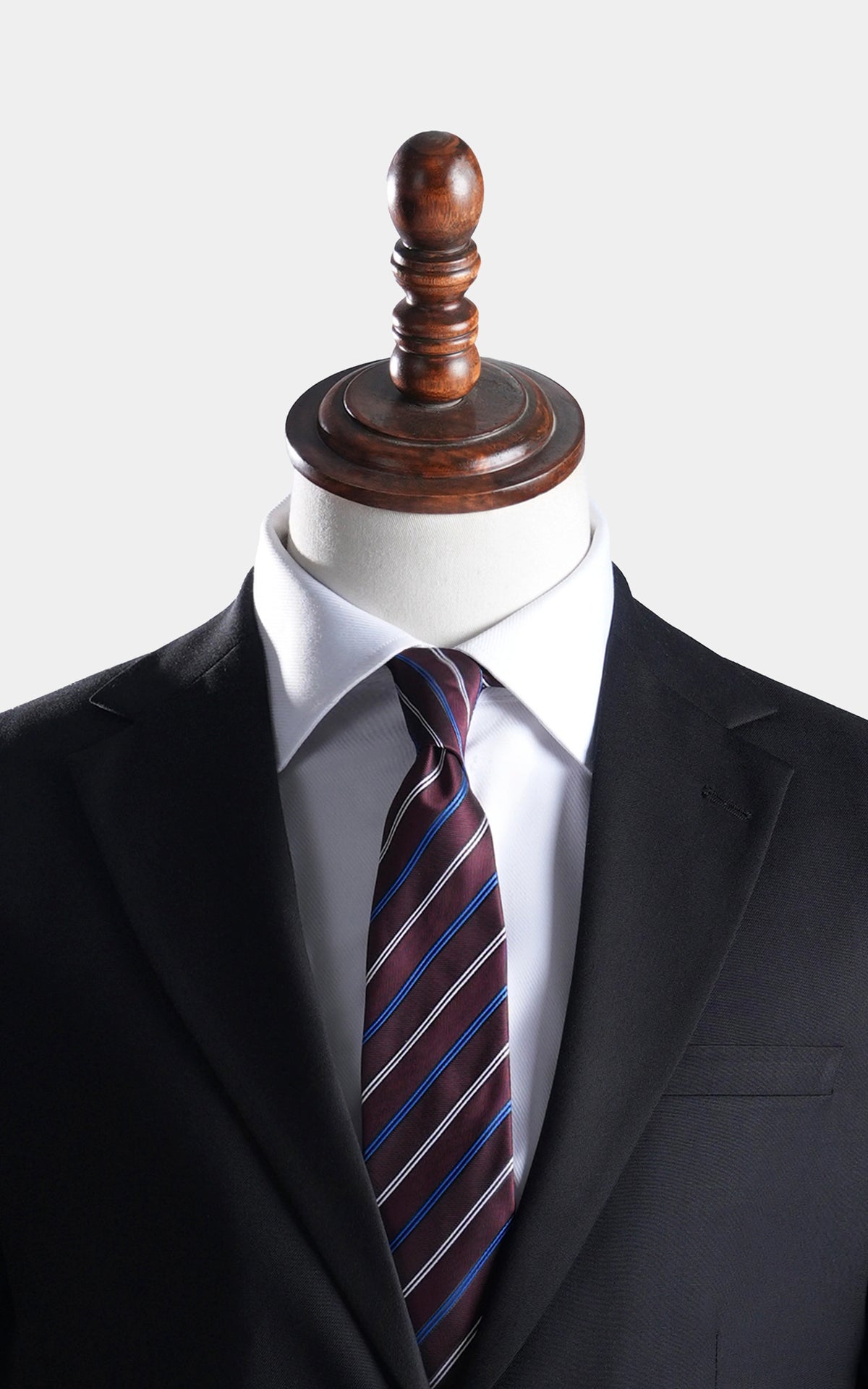 Black suit jacket with notch lapels, white shirt, and striped necktie