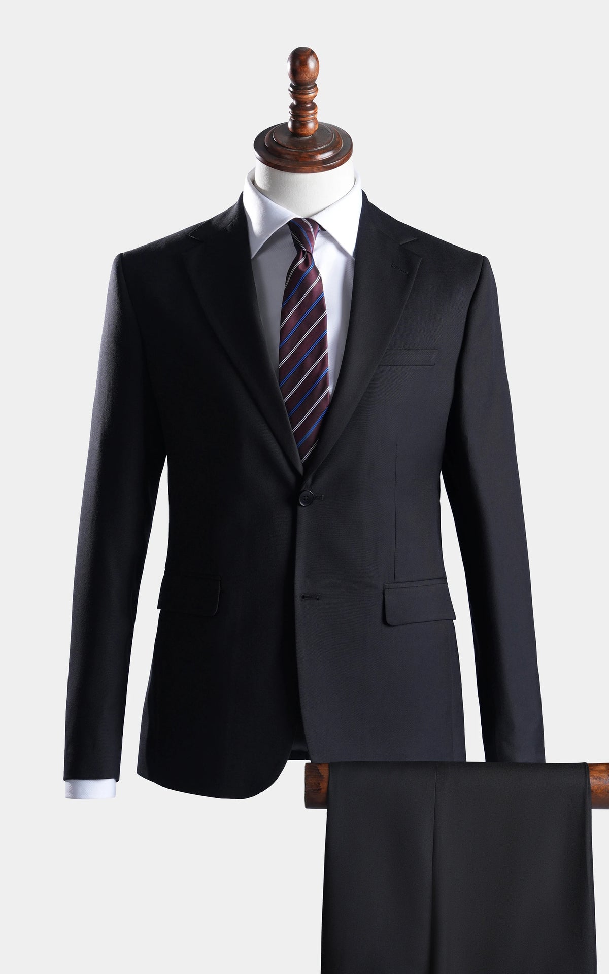 Black two-piece suit with notch lapels, long sleeves, and matching trousers