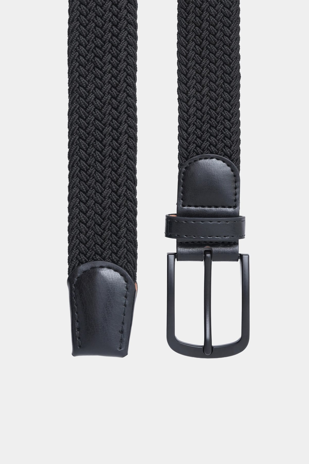 Casual woven belt close-up with silver buckle and stitched dark leather end