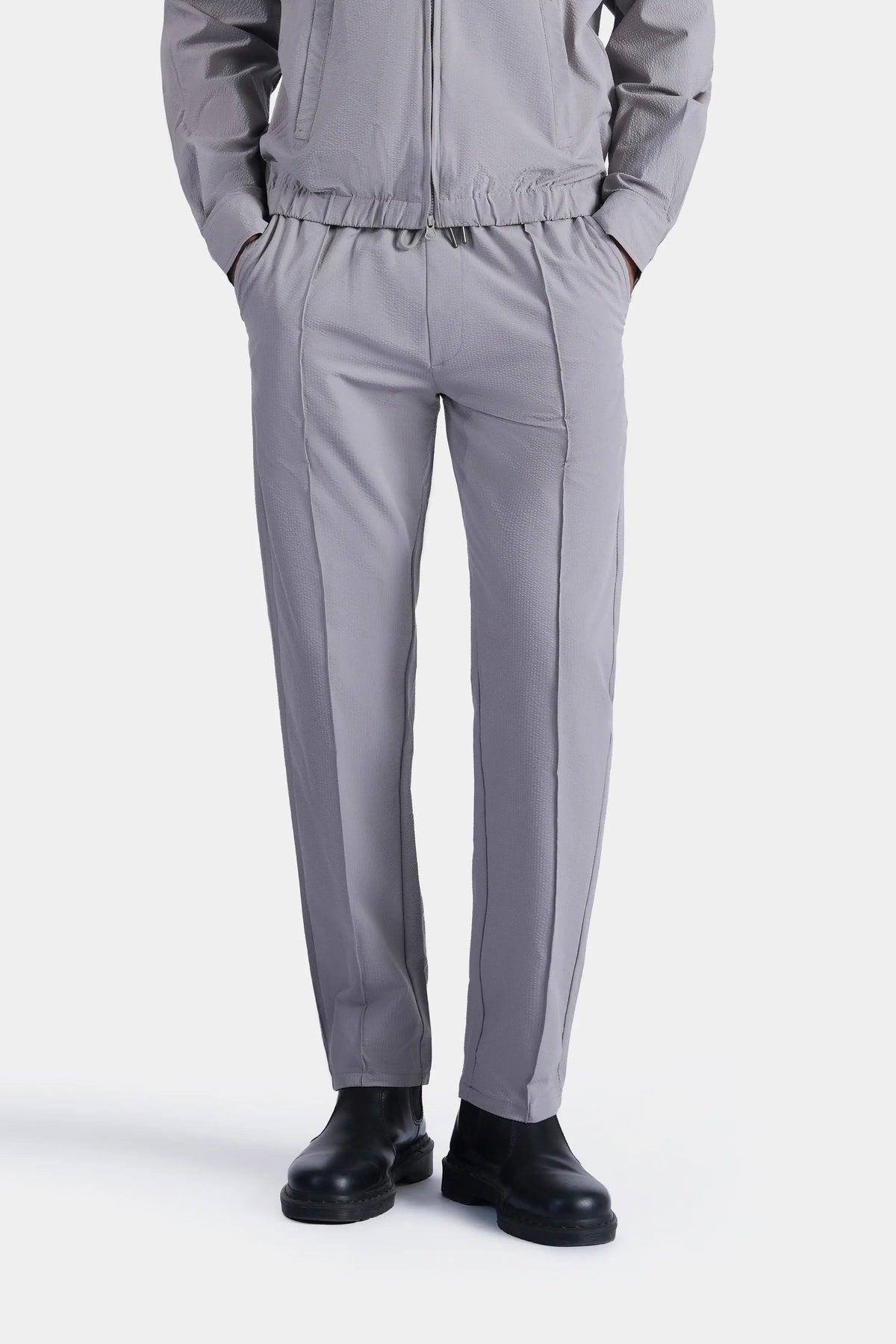 Light grey seersucker trousers with elastic waist and tapered legs