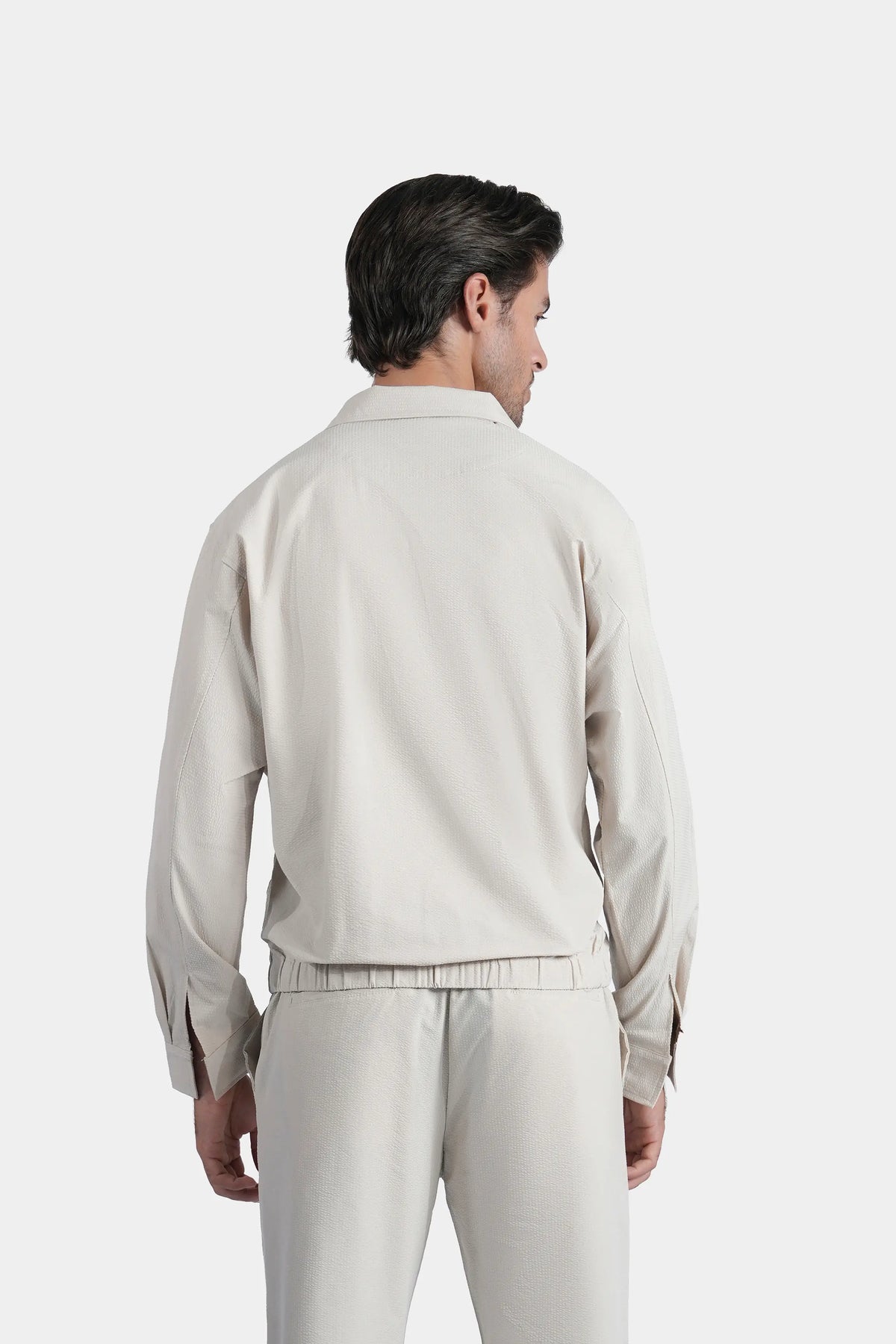 Beige seersucker raglan jacket back view with zip closure and stand collar