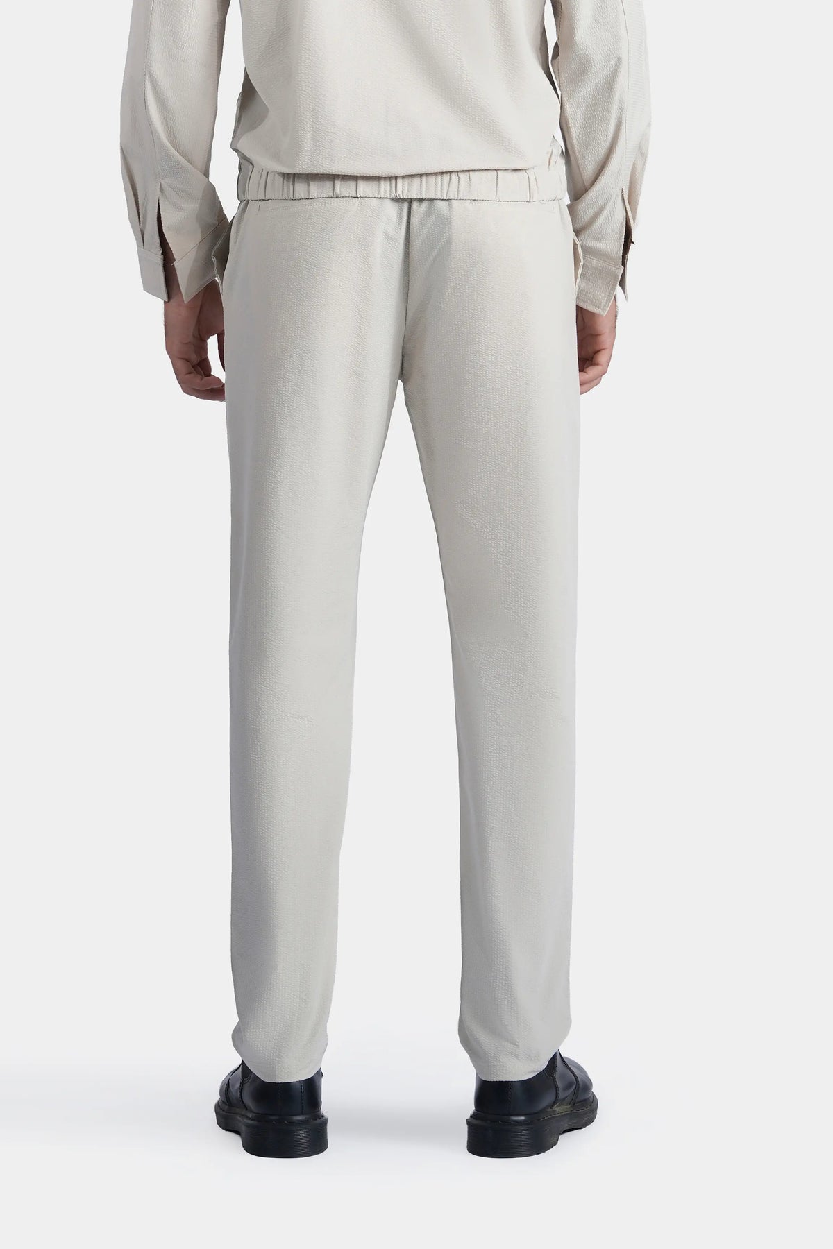 Beige seersucker trousers with elastic waistband and cuffed hems