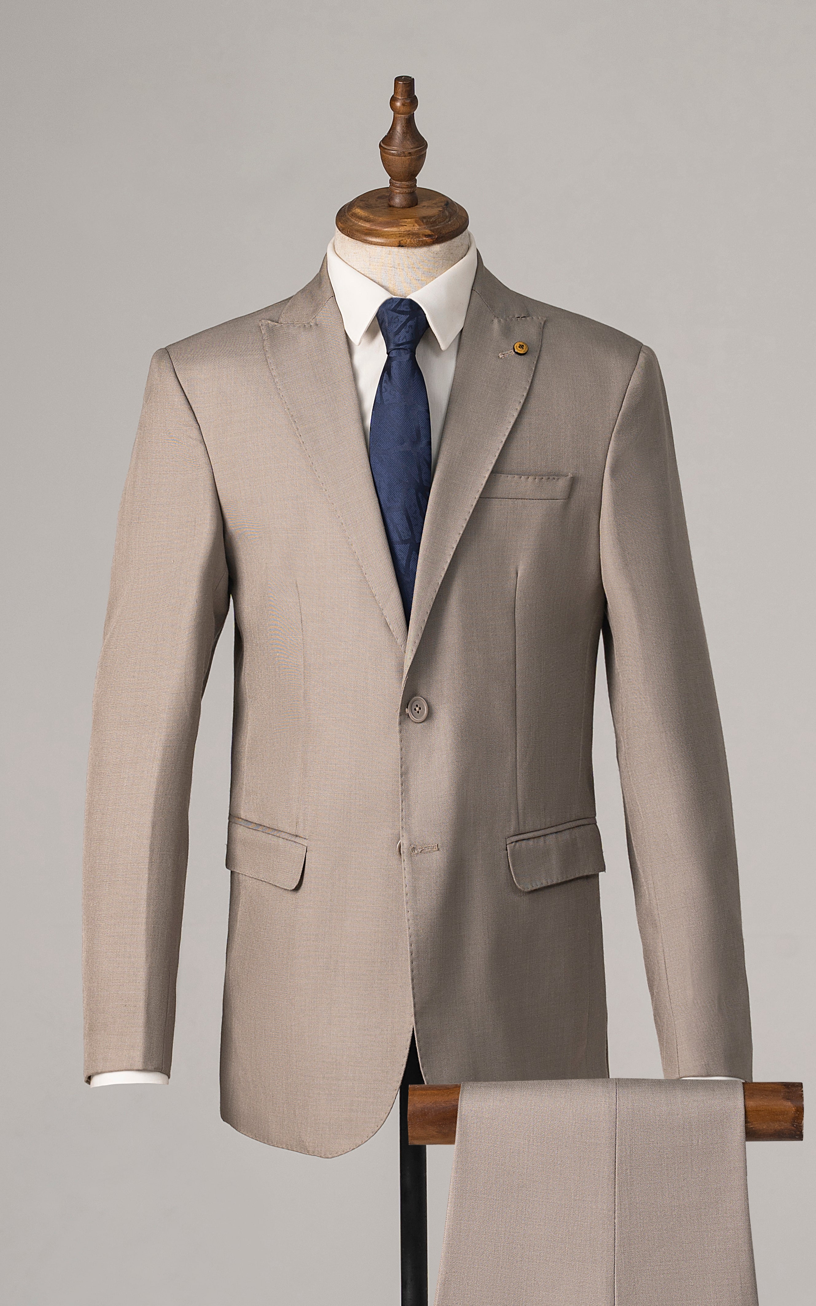 Beige two-piece suit jacket with notched lapels, welt pockets, and matching trousers