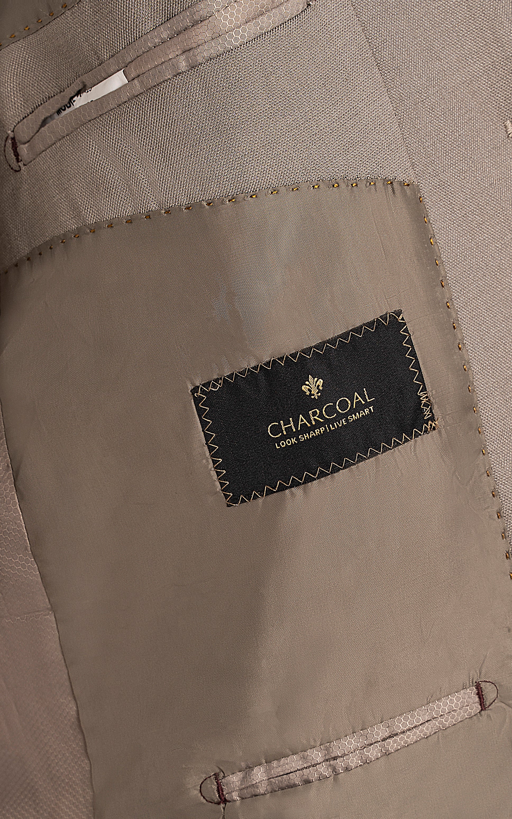 Beige suit jacket inner label area with CHARDCOAL tag and stitched pocket
