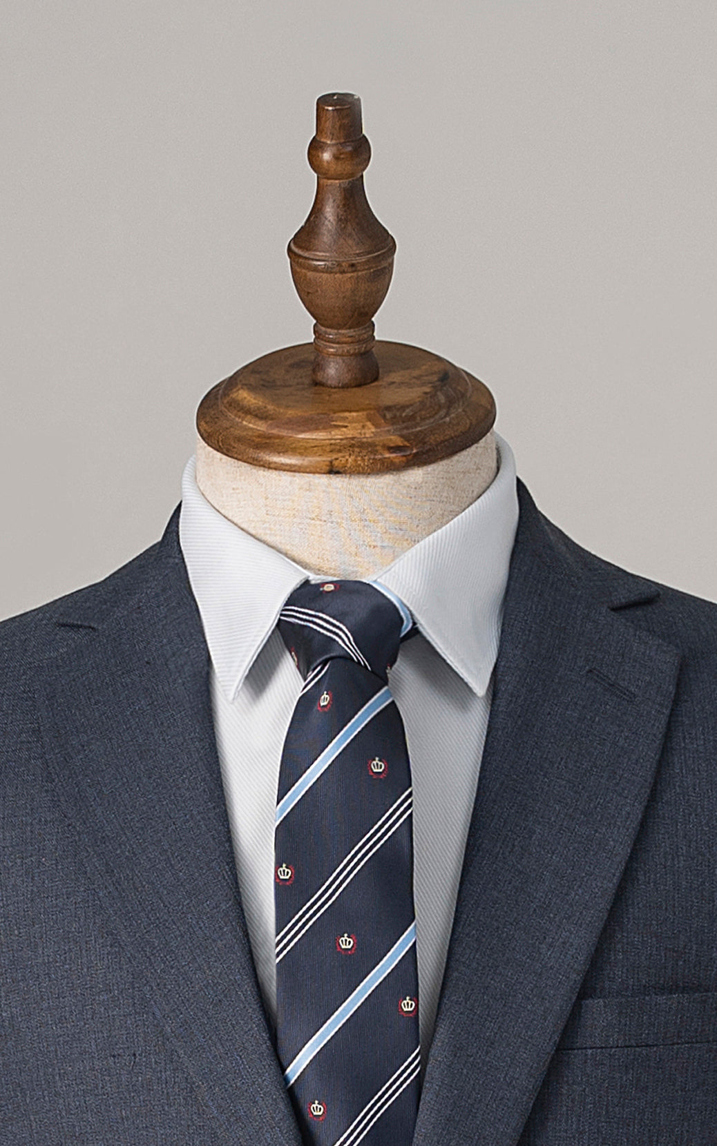 Blue suit jacket lapels with striped tie and white dress shirt