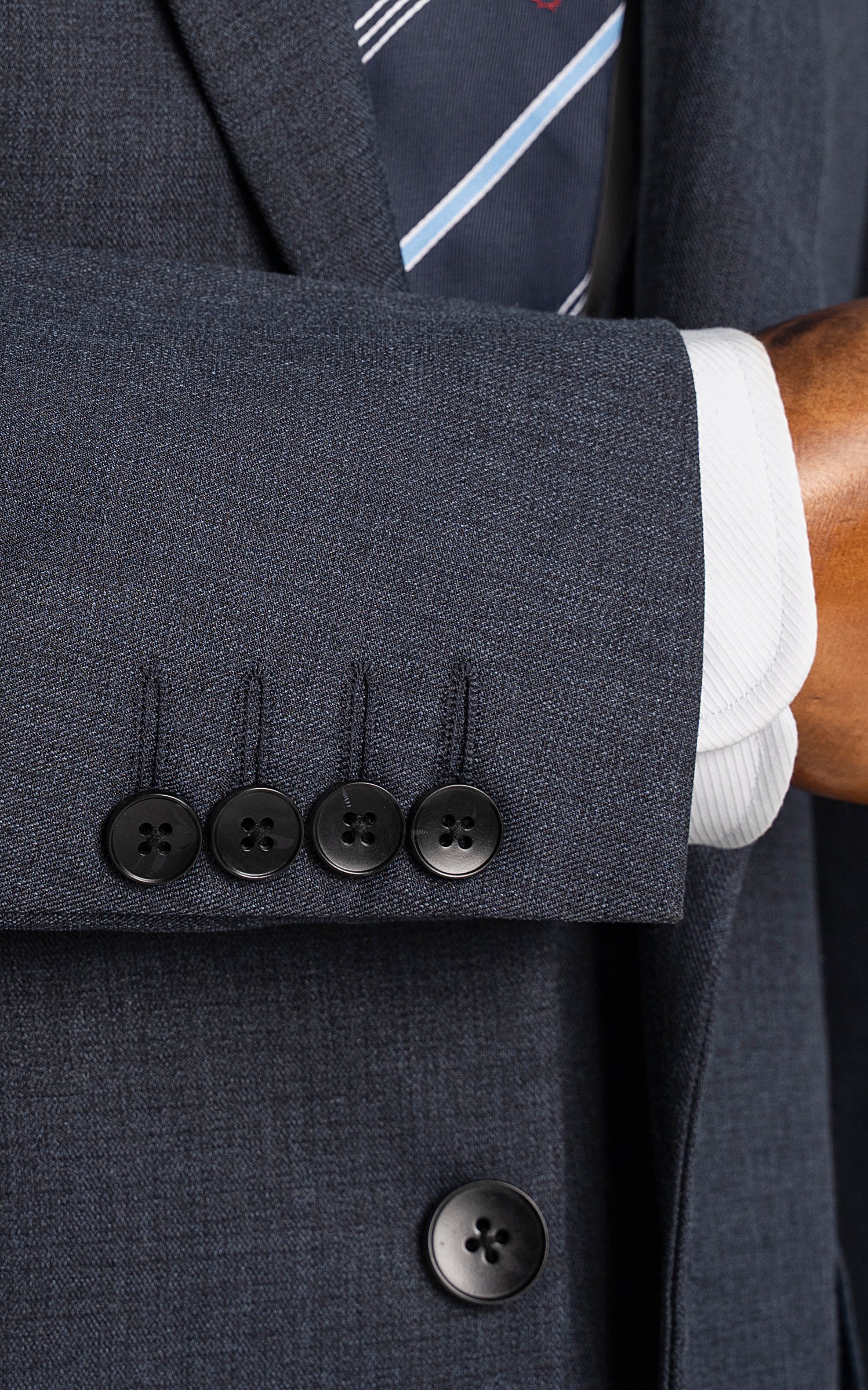 Blue suit jacket cuff with four buttonholes and dark buttons