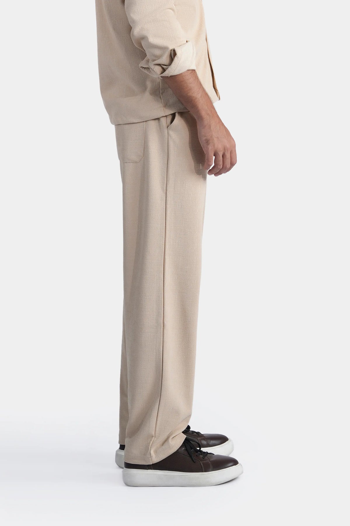 Beige loose-fit trousers with slim straight cut and side hand pockets