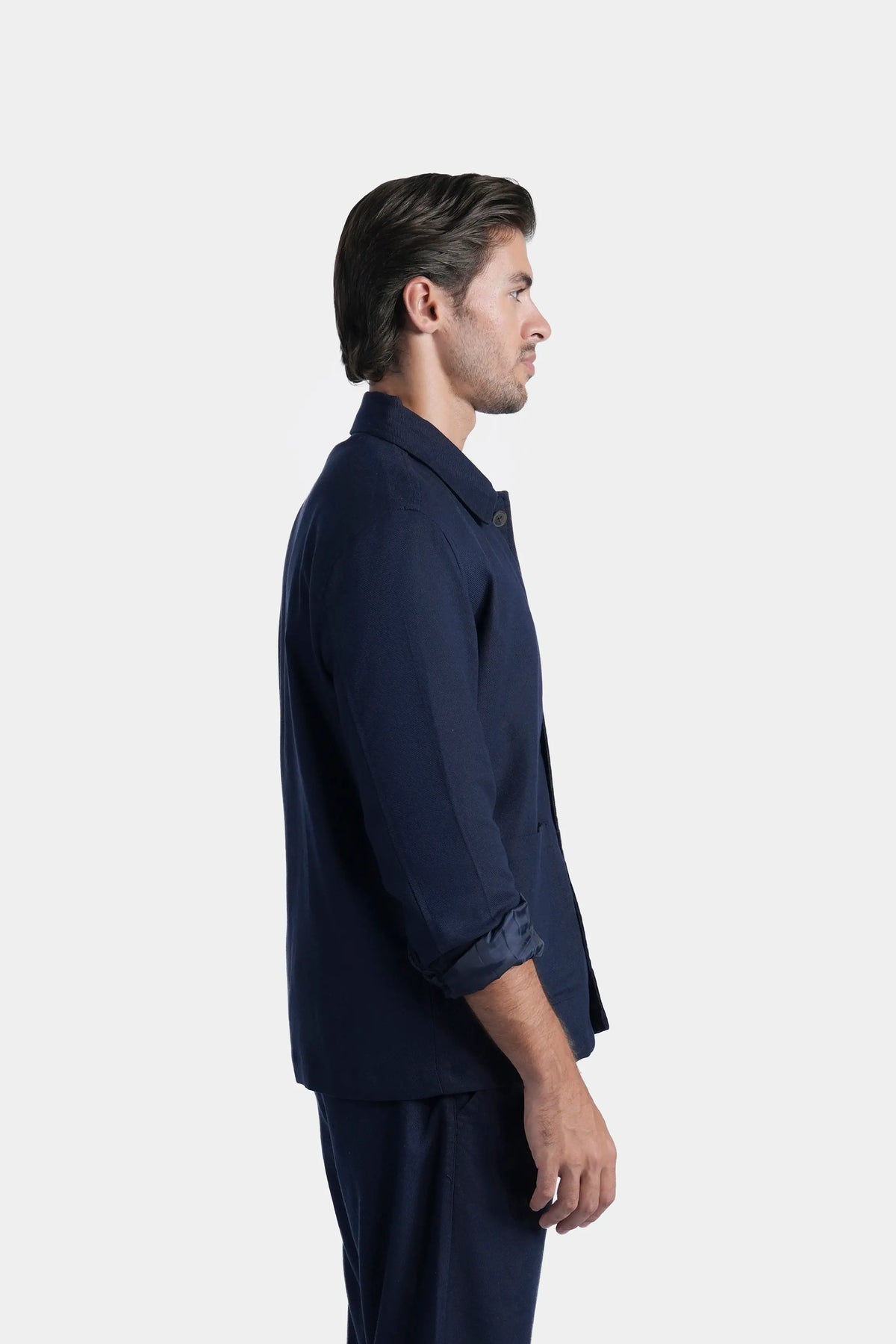 Navy shacket in side profile, full sleeves with button closure