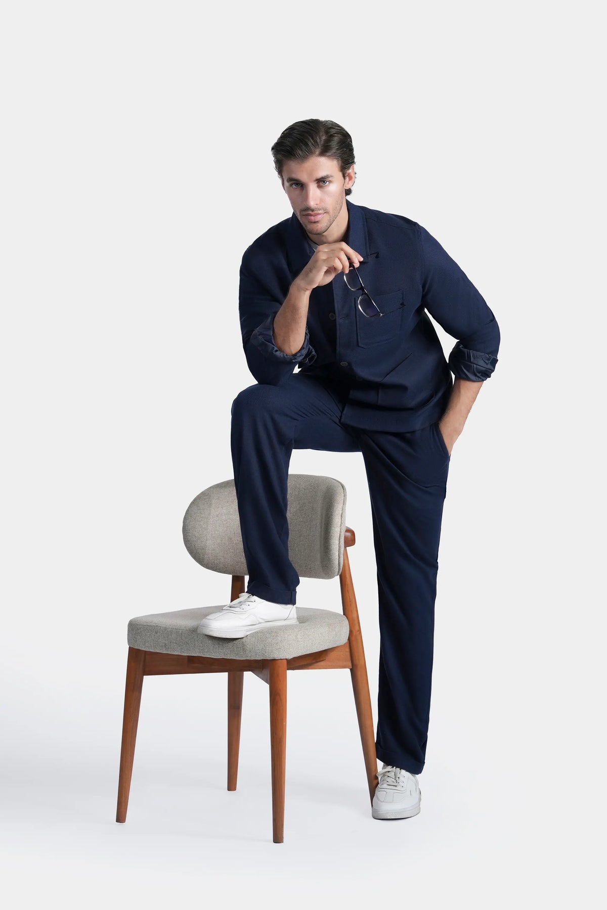 Navy shacket with full sleeves, button front and chest pocket, seated pose