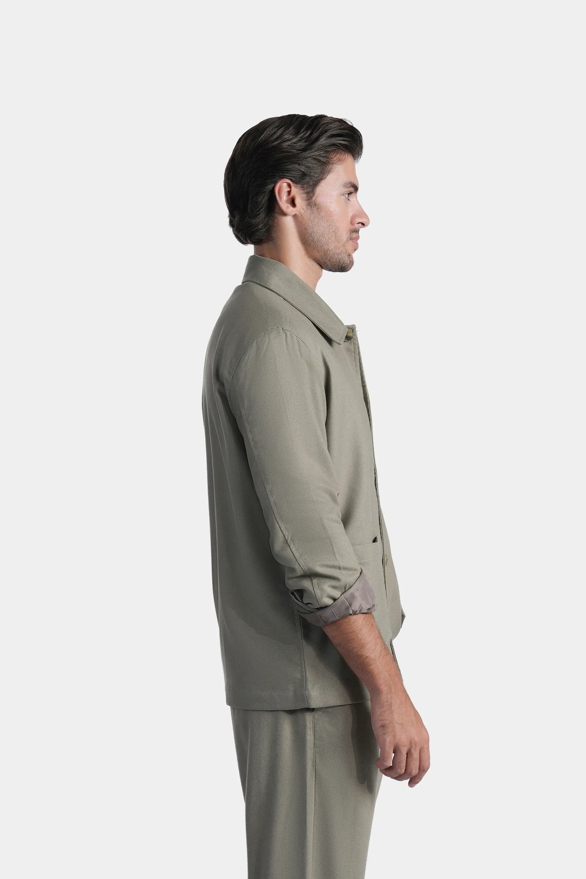 Olive shacket with pointed collar and button cuffs, side view