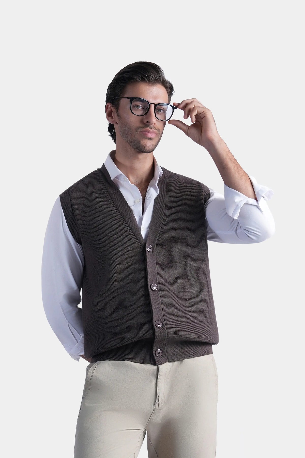 Brown V-neck sleeveless knit sweater vest with button front detail over white shirt