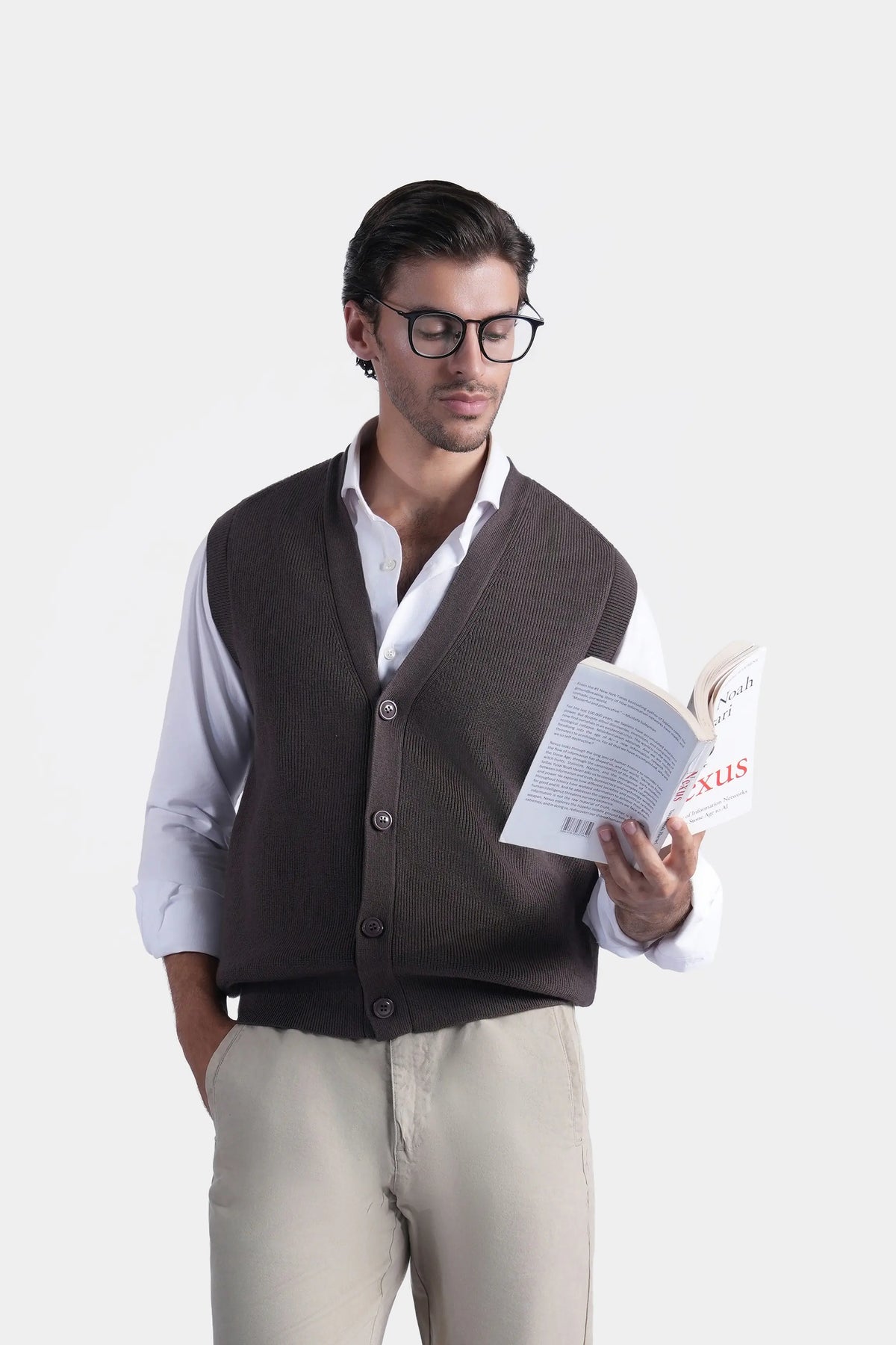 Brown V-neck sleeveless knit sweater vest with button front, worn over white shirt