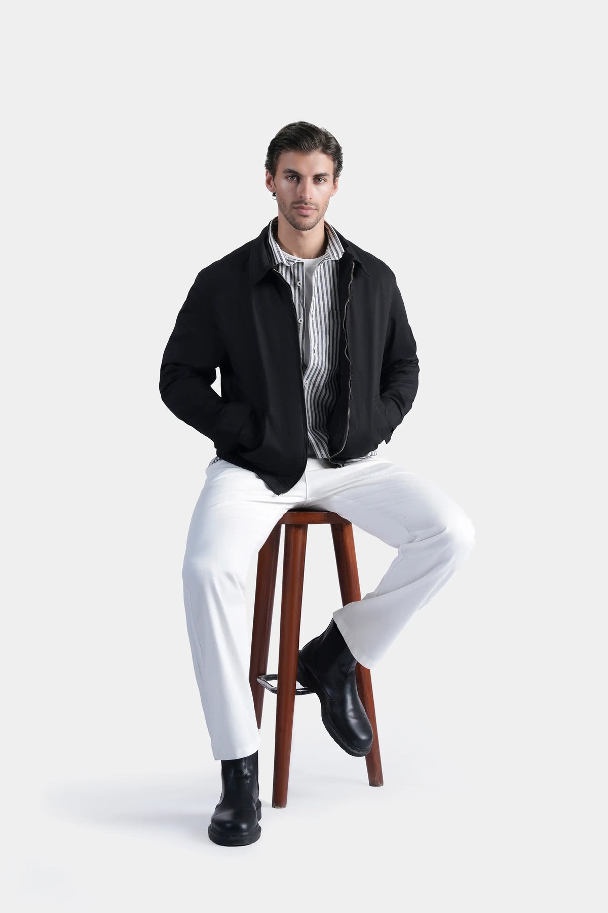 Black relaxed-fit jacket front view, zip-up with stand collar and ribbed cuffs