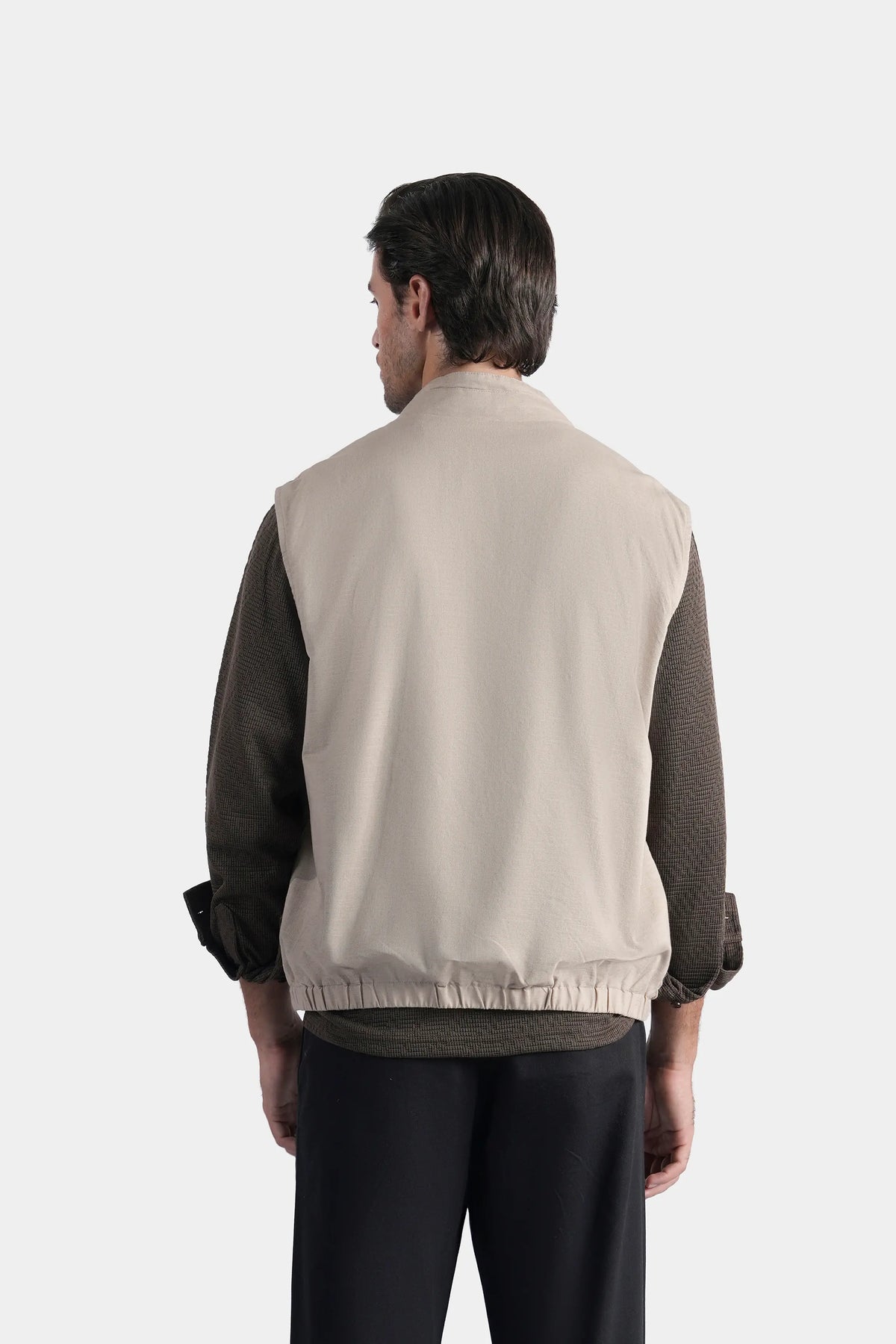 Reversible sleeveless jacket back view, khaki panel with ribbed hem