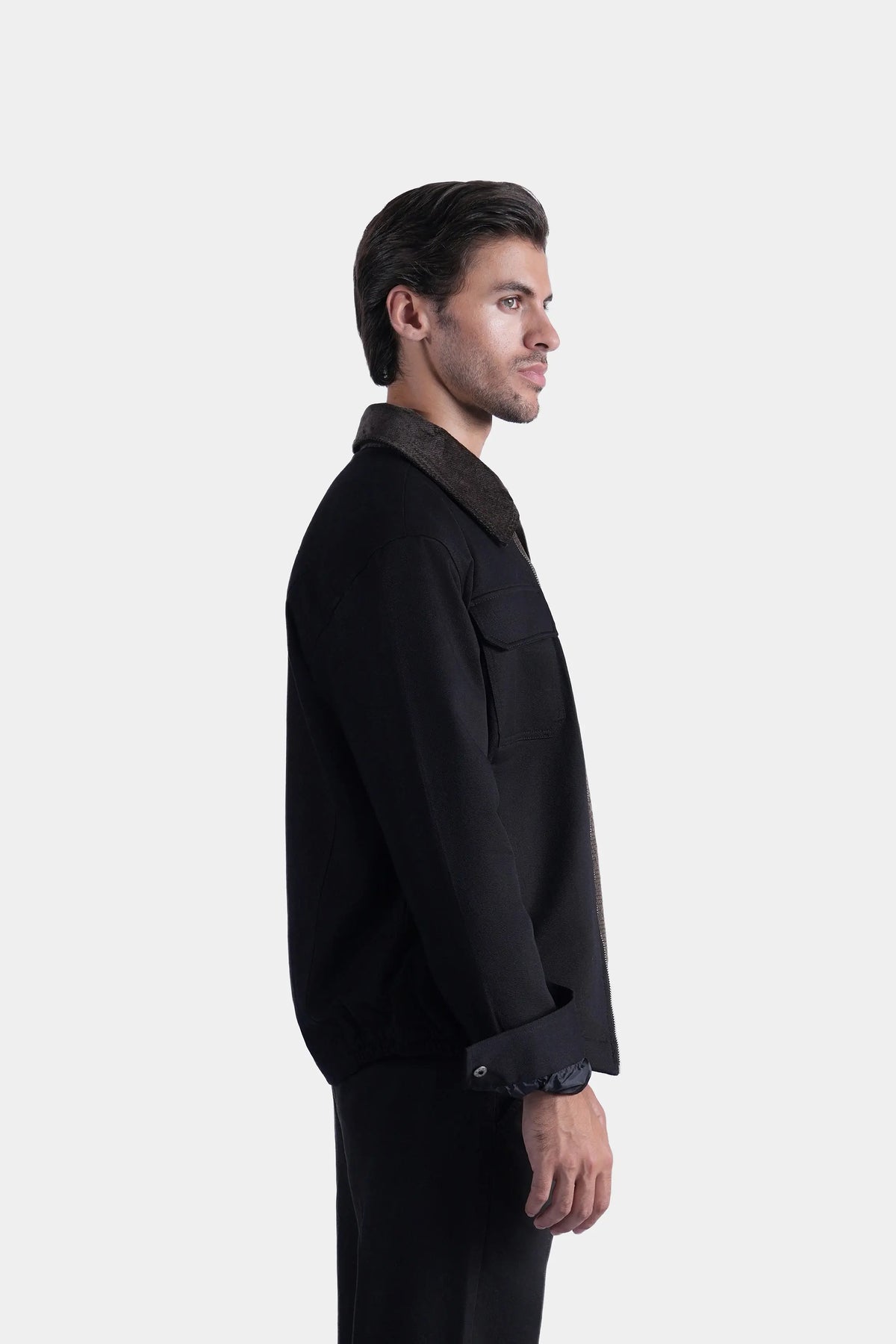 Men's black relaxed-fit long-sleeve jacket, side view with flap pockets and cuffs