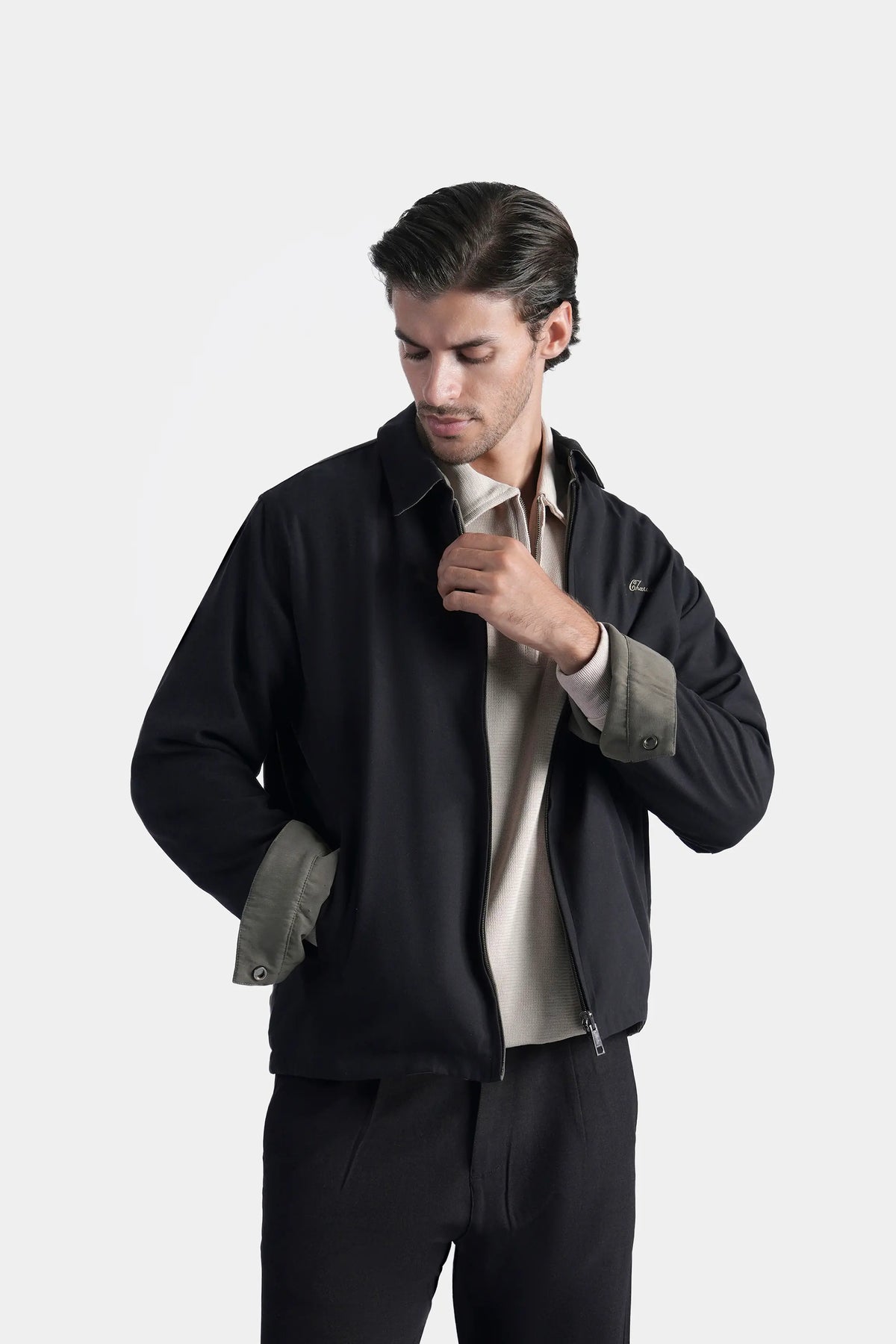 Black reversible collar jacket with zipper front; olive lining shows at cuffs and hem