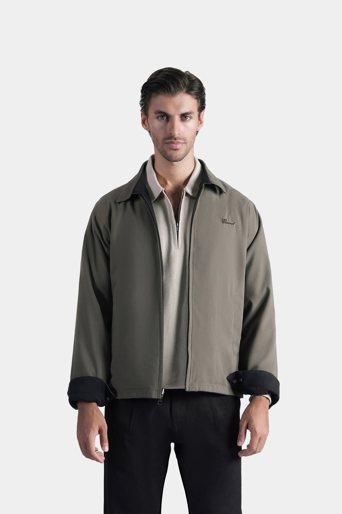 Olive reversible collar jacket with zipper front and black cuffs, standing collar