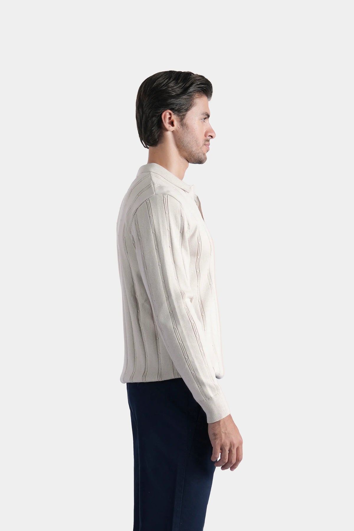 Beige knit sweater with regular collar, long sleeves, and vertical ribbed texture