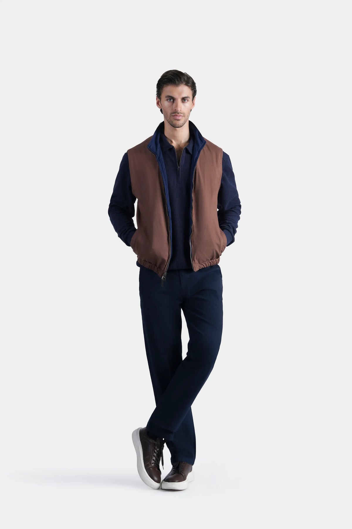 Reversible sleeveless jacket with rust-brown body, stand collar, front zipper