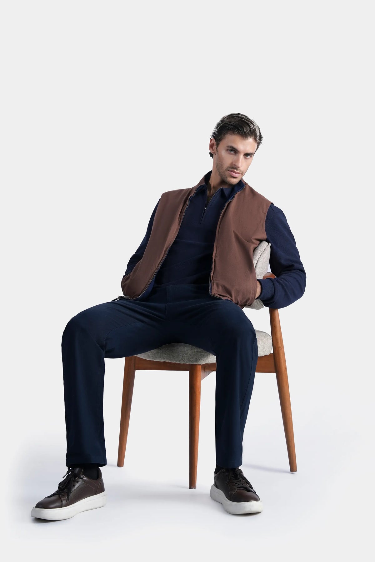 Reversible sleeveless jacket, navy side with rust-brown front panels and stand collar