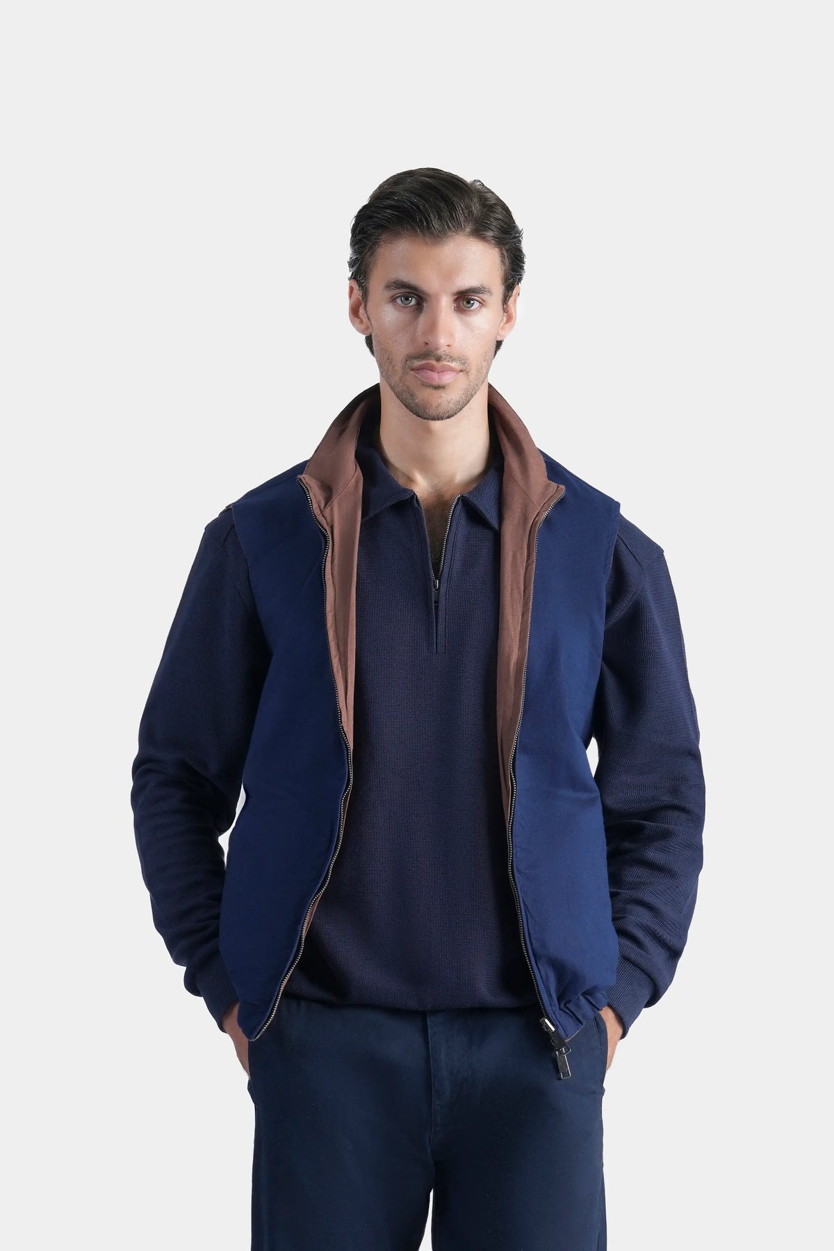 Reversible sleeveless jacket in navy with rust-brown trim, front zipper, stand collar