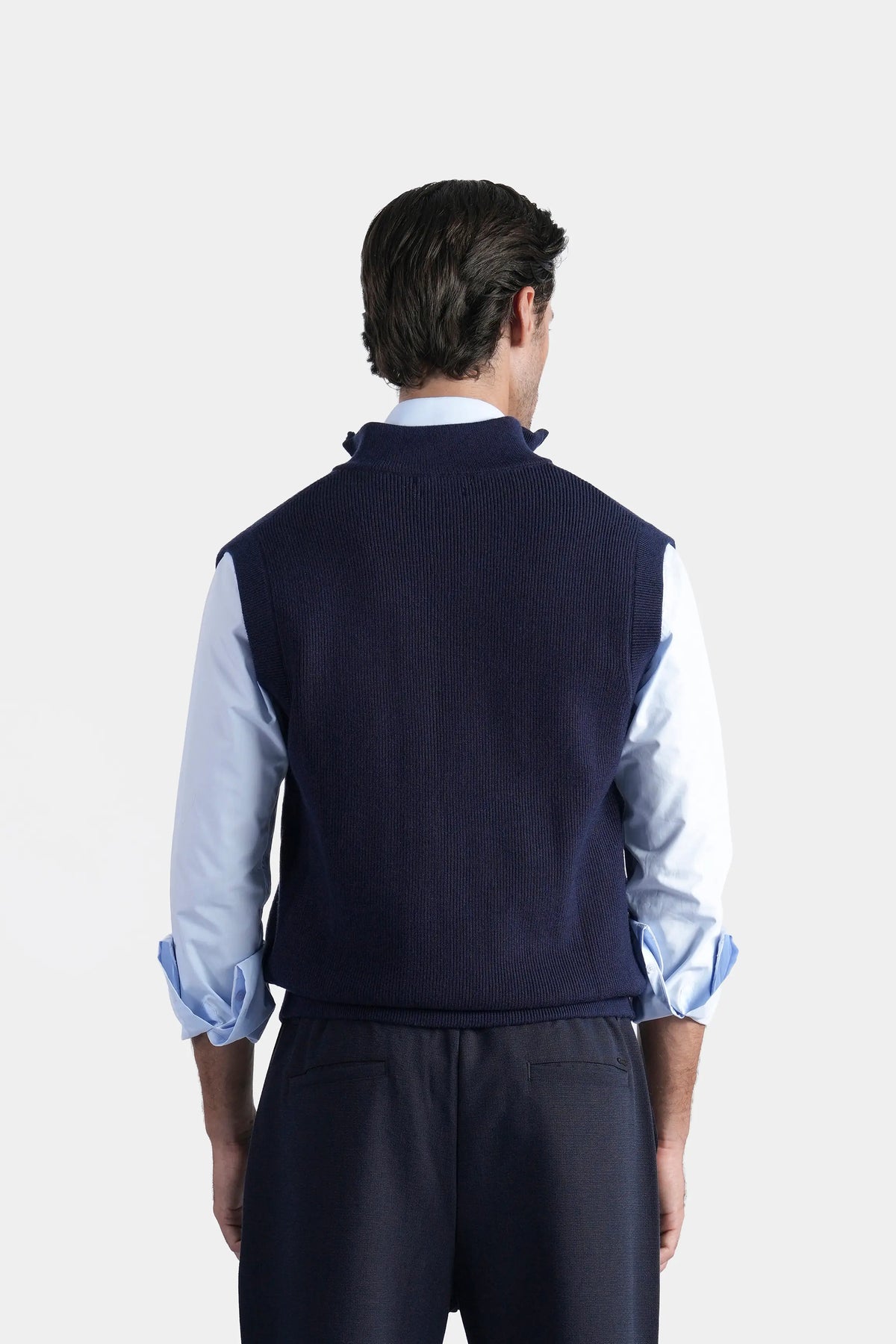 Navy sleeveless knitted sweater with high stand collar, back view