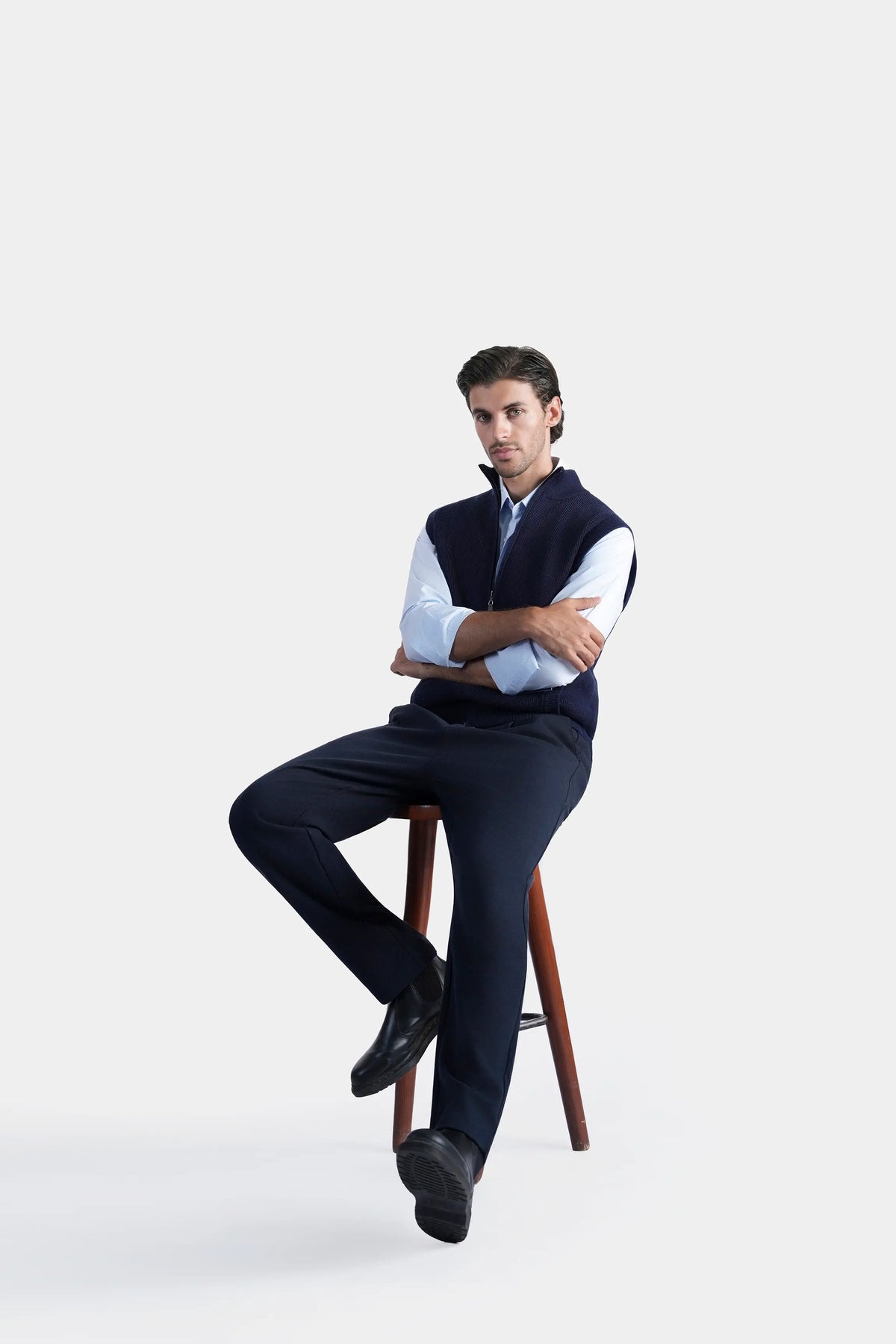 Navy sleeveless knitted sweater with high stand collar, zip-front styling