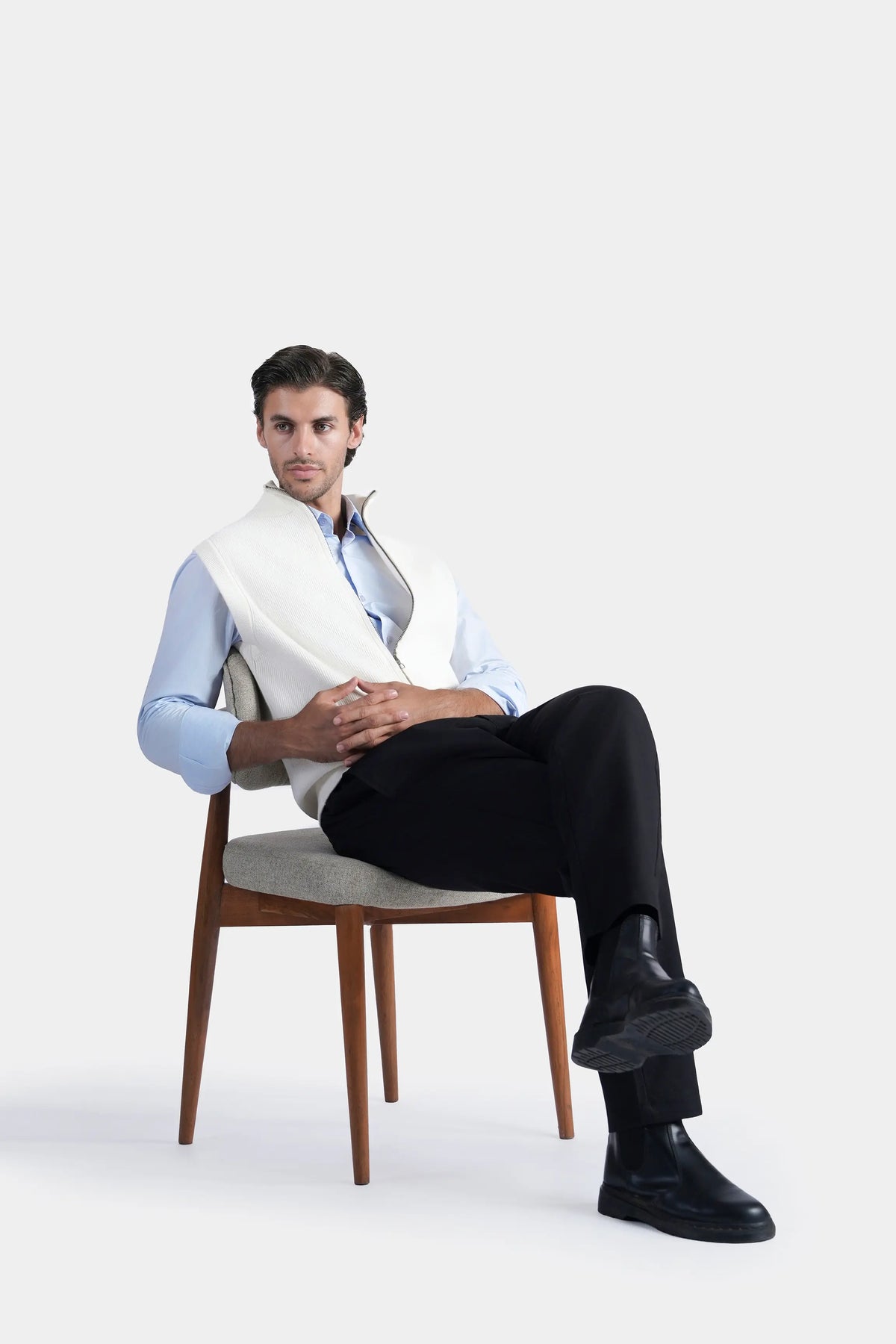Off-white sleeveless knit sweater vest with high stand collar, zipped front