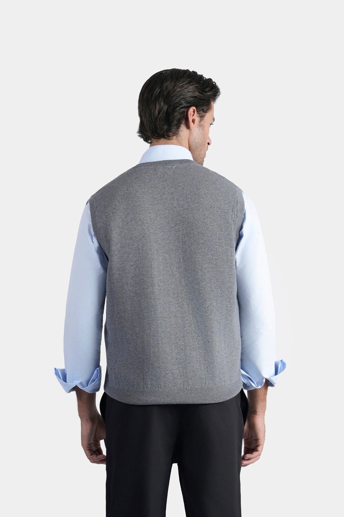 Grey sleeveless knitted sweater vest, back view with smooth yoke and textured knit