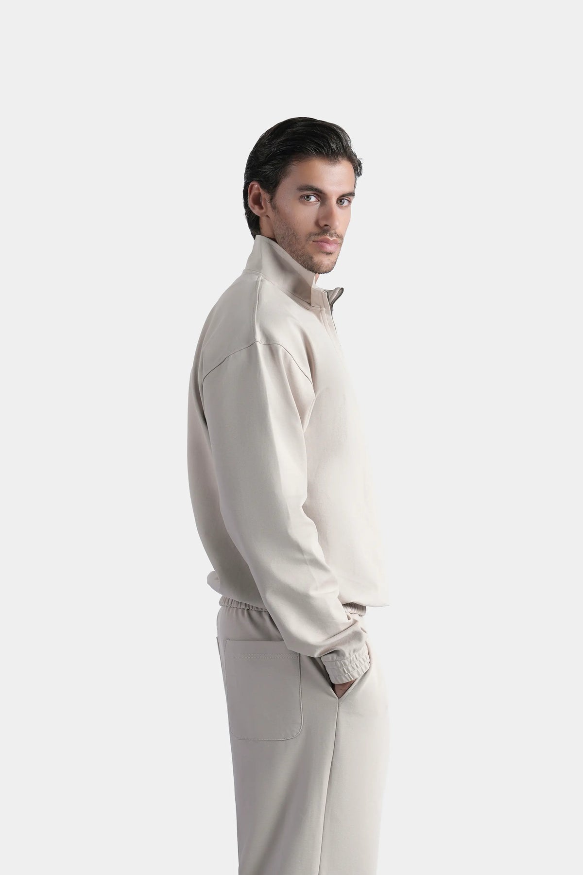 Beige quarter-zip mock neck sweatshirt with long sleeves, side profile