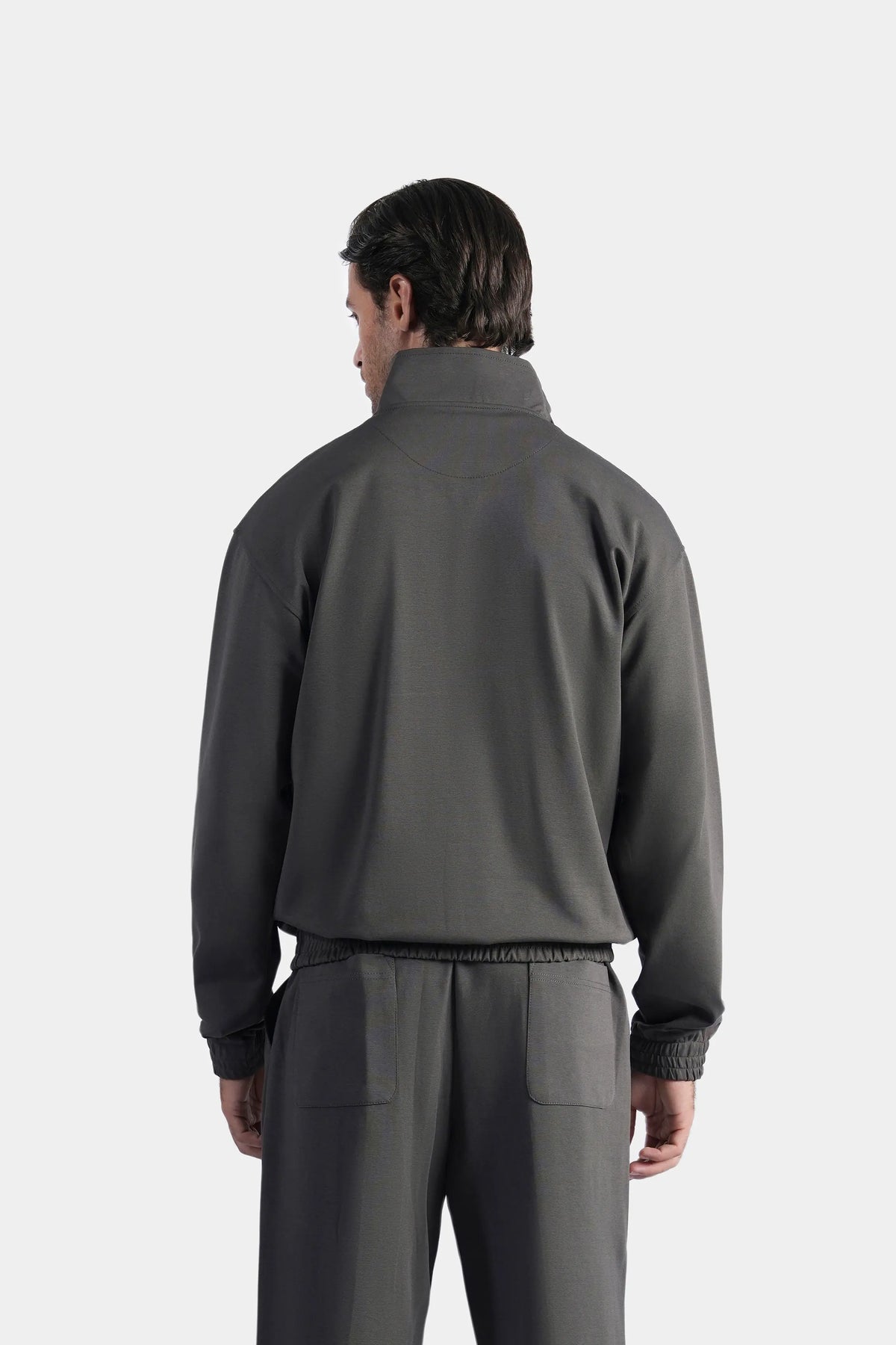 Grey quarter-zip mock neck pullover sweatshirt, back view with ribbed cuffs