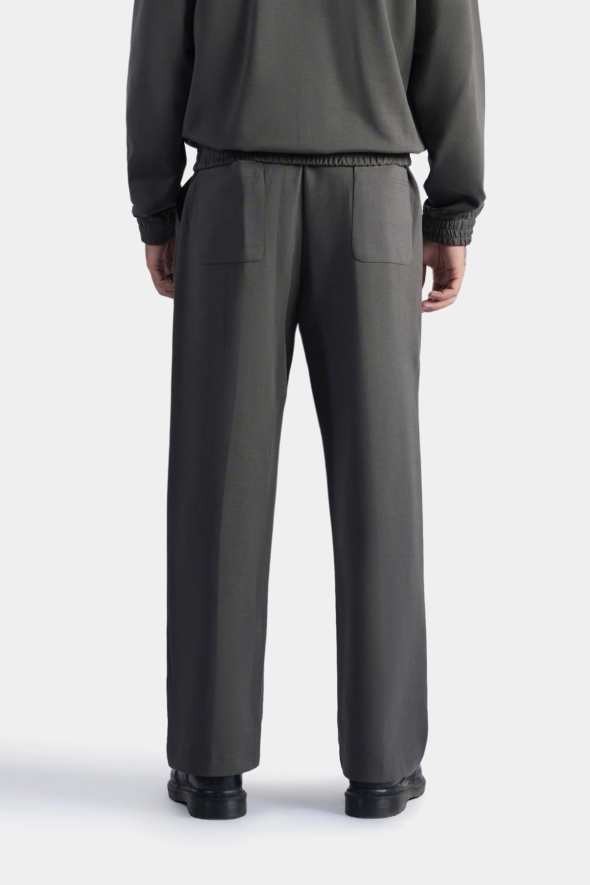 Grey scuba trousers back view with elastic waistband and welt pockets