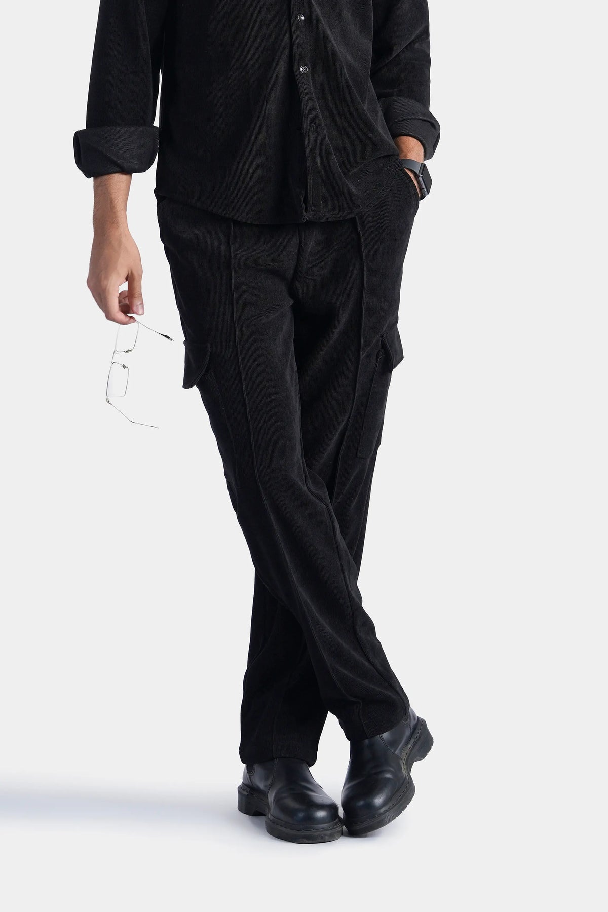 Black corduroy cargo trousers with side flap pockets and relaxed fit