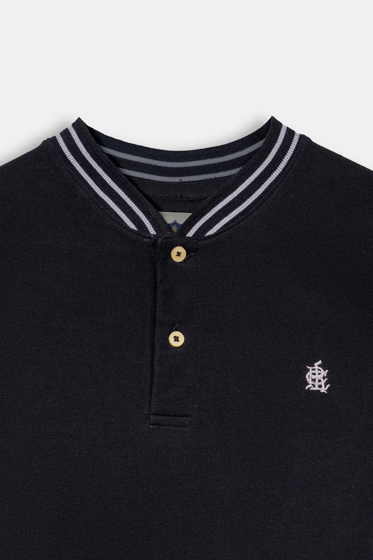 Black henley collar with striped trim, two gold buttons, and chest logo