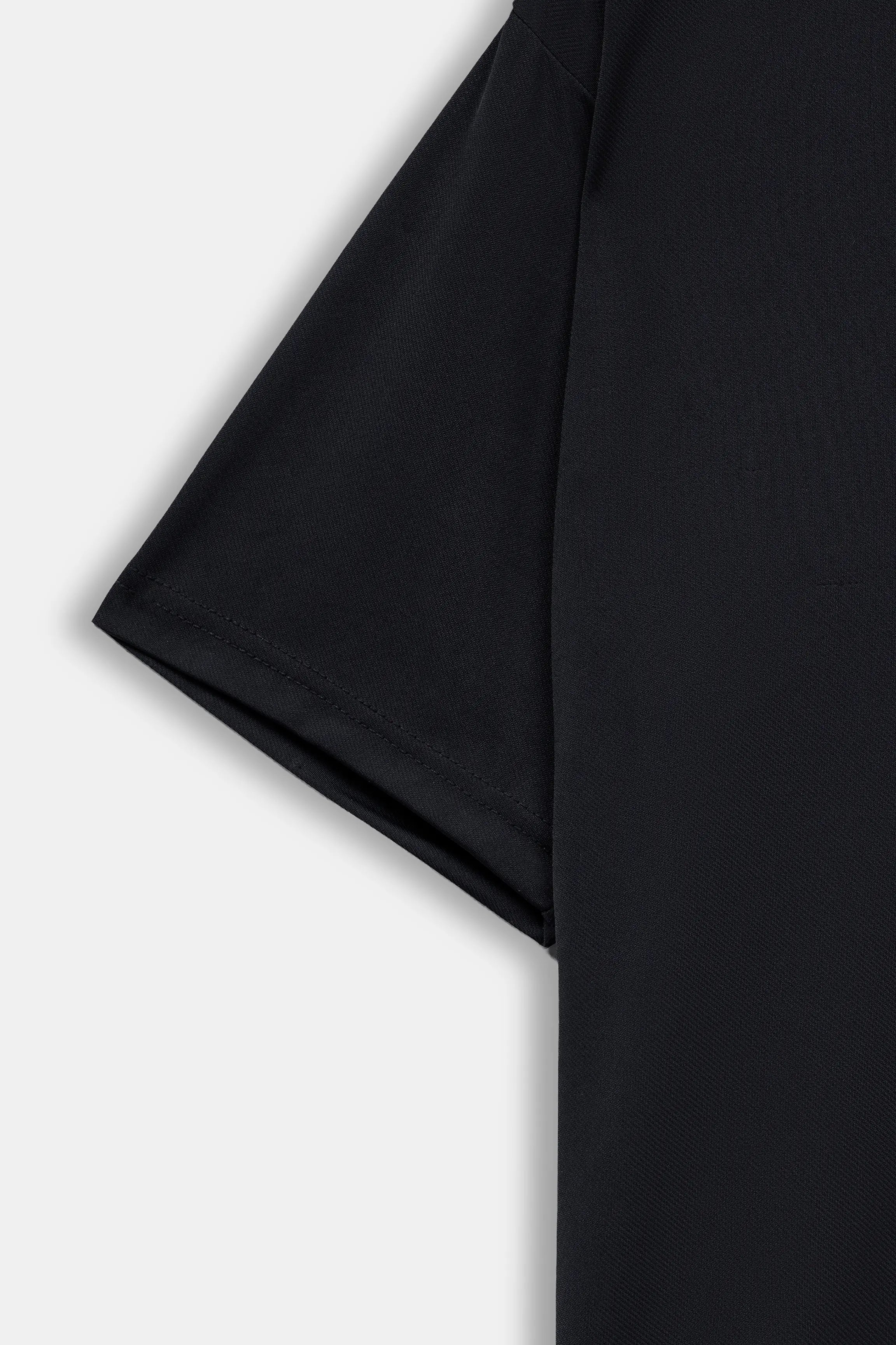 Black polo shirt side panel and short sleeve hem detail