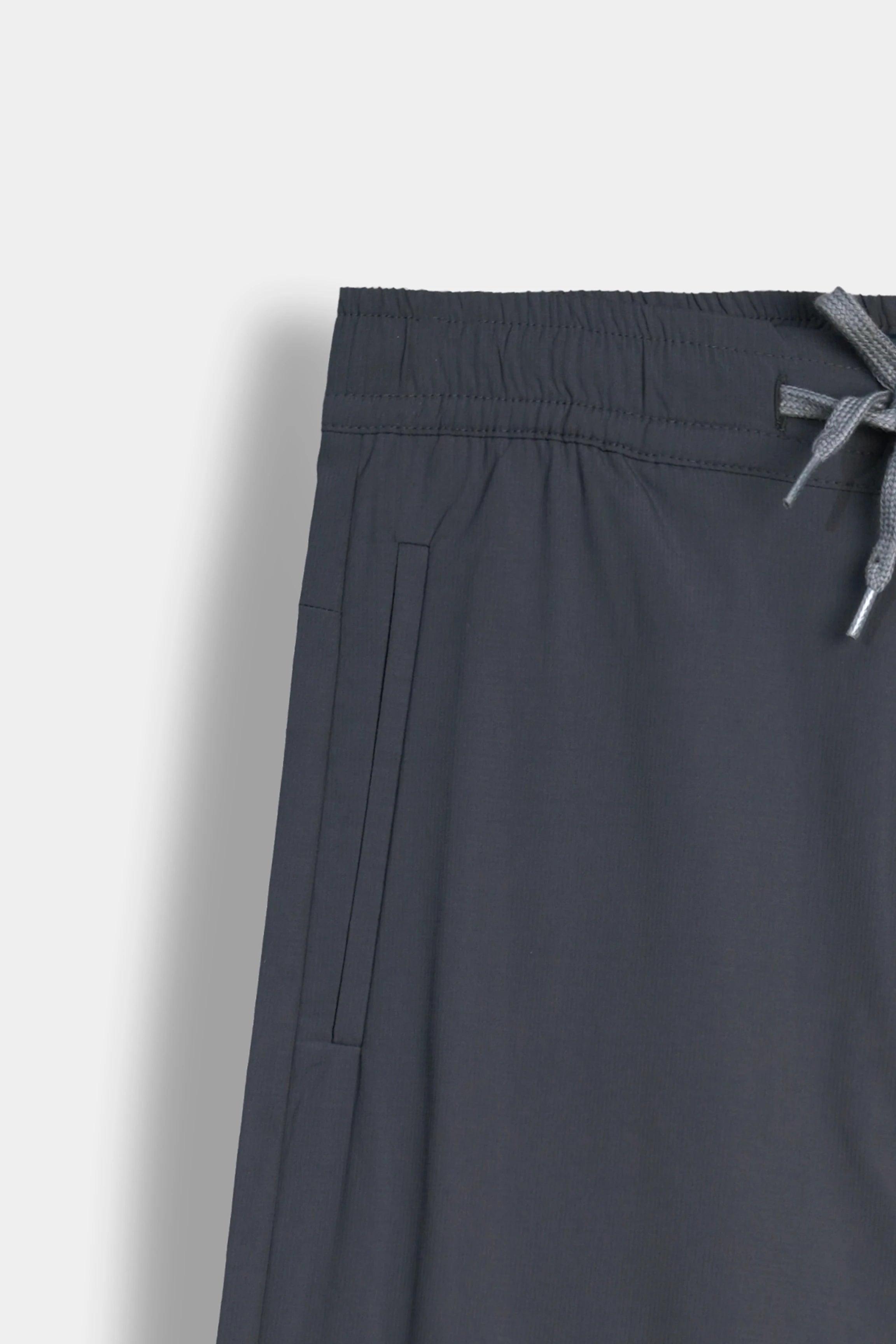 Dark grey casual trousers with elastic waistband and drawstring tie