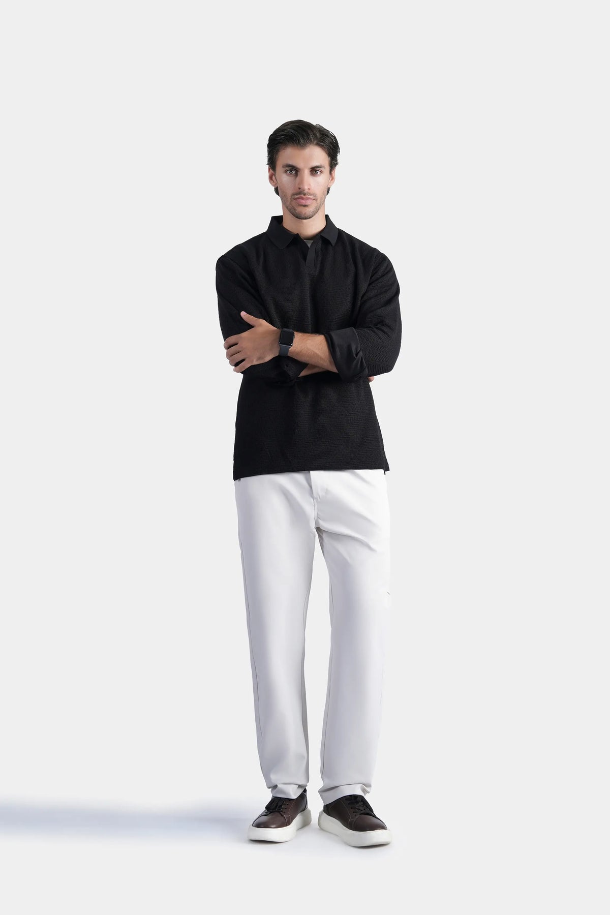 Black long-sleeve polo shirt with button placket, pointed collar, and ribbed cuffs