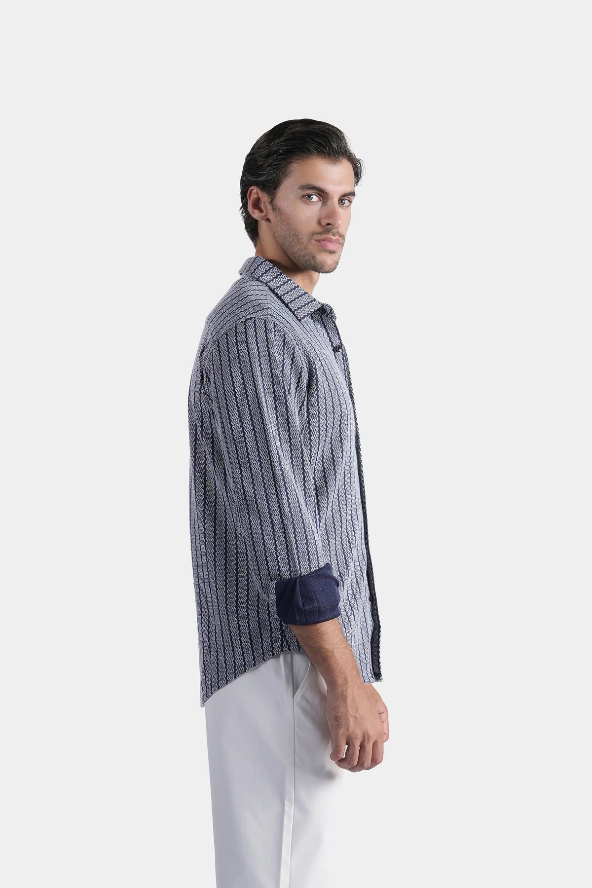 Navy long-sleeve self-textured button-up shirt, side profile view